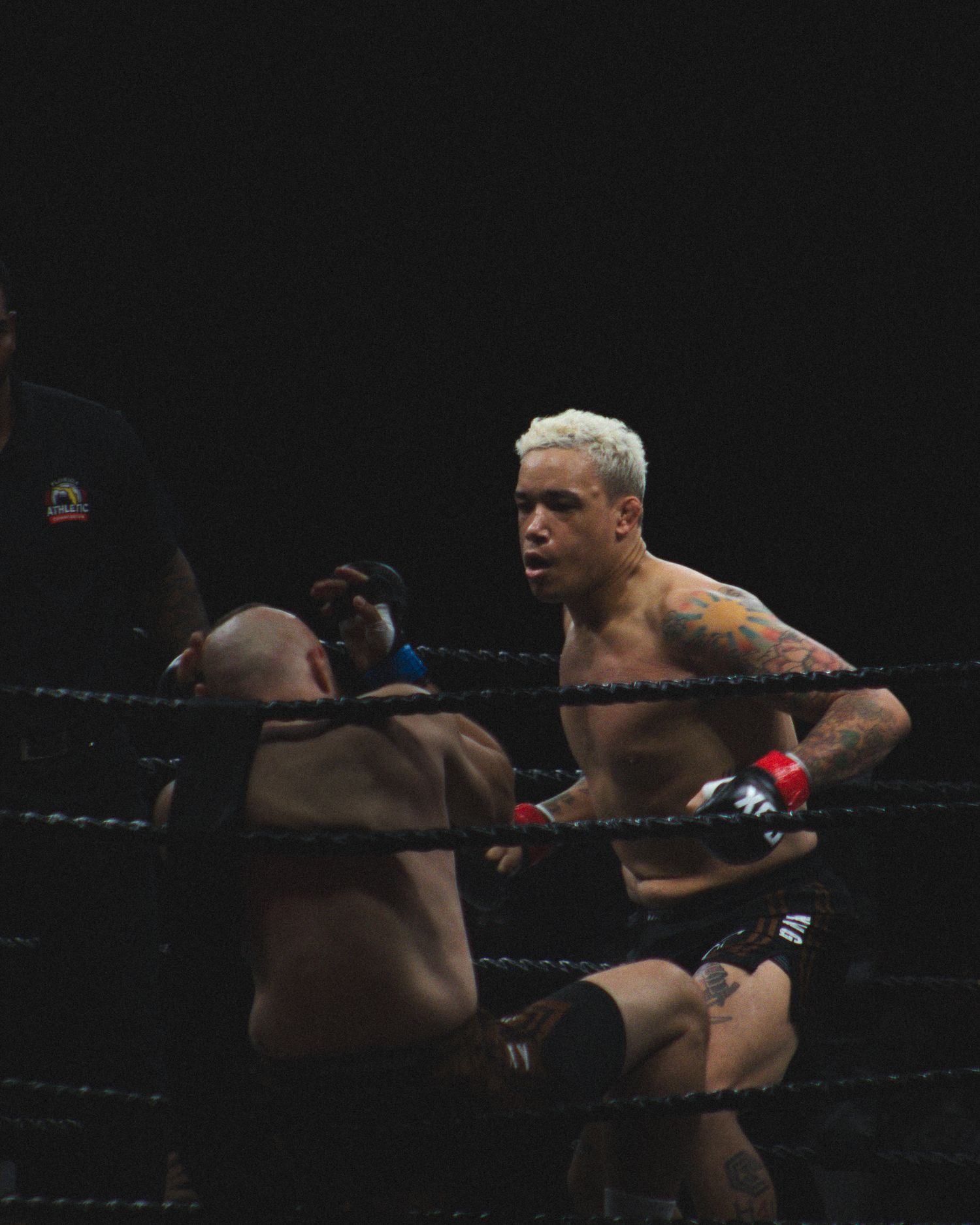 Two fighters exchange powerful strikes during an intense boxing match.