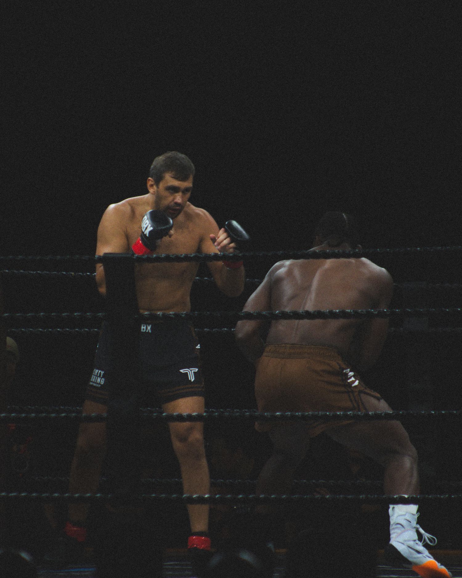 Boxers engage in close combat during an intense professional match.