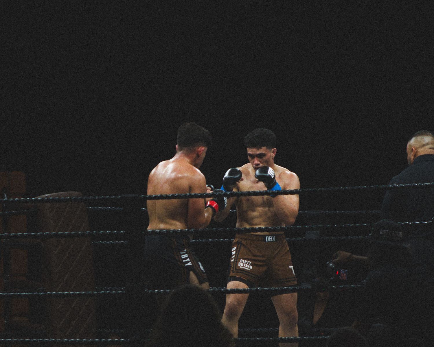 Boxers engage in close-range combat during an intense match.