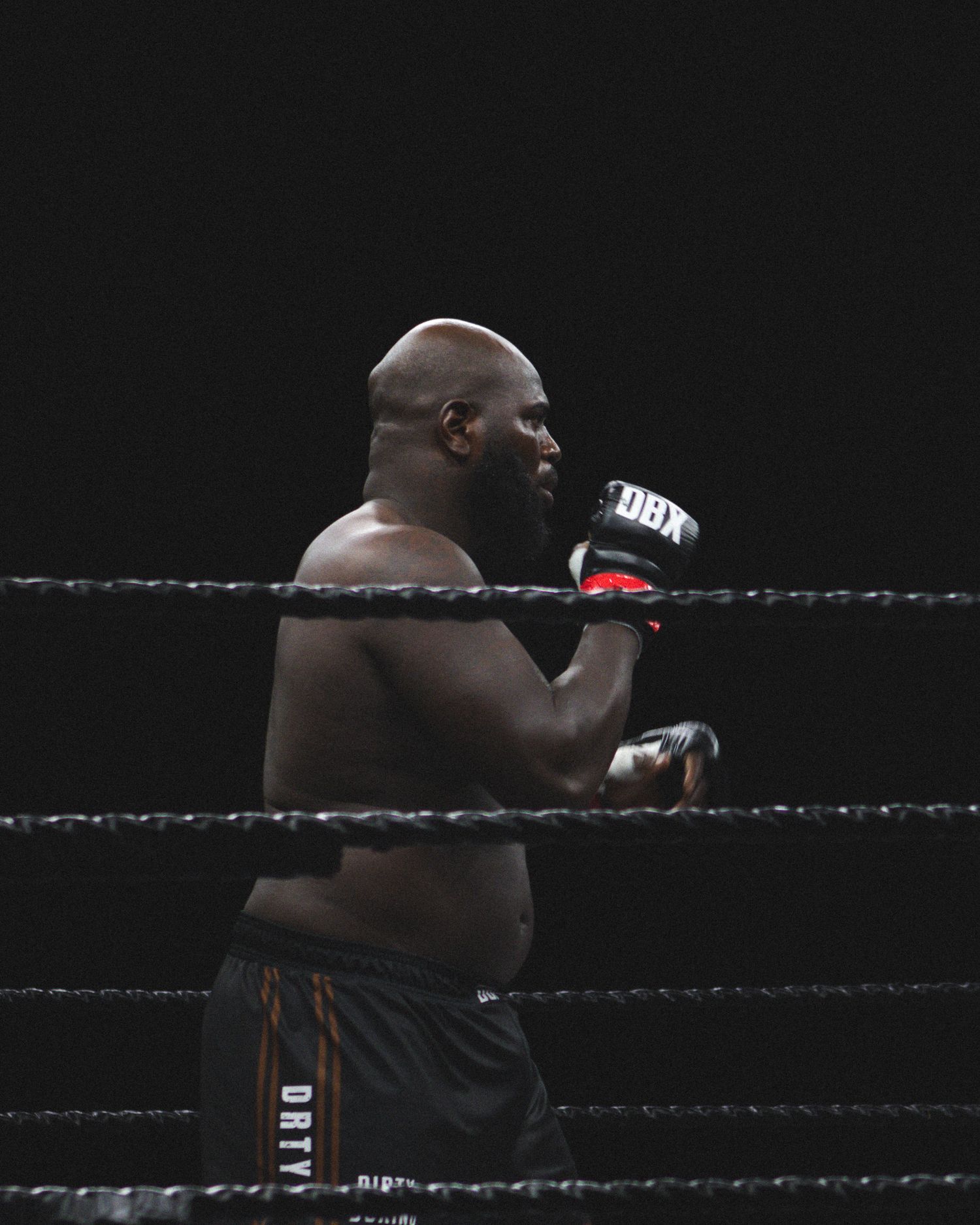 A boxer in fighting stance throws a combination of punches during a match.