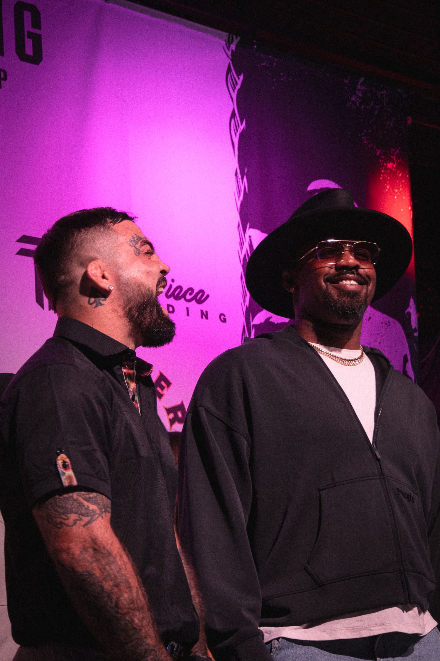 Two performers share a moment under purple stage lighting at an entertainment venue.
MIke Perry and Jon Jones