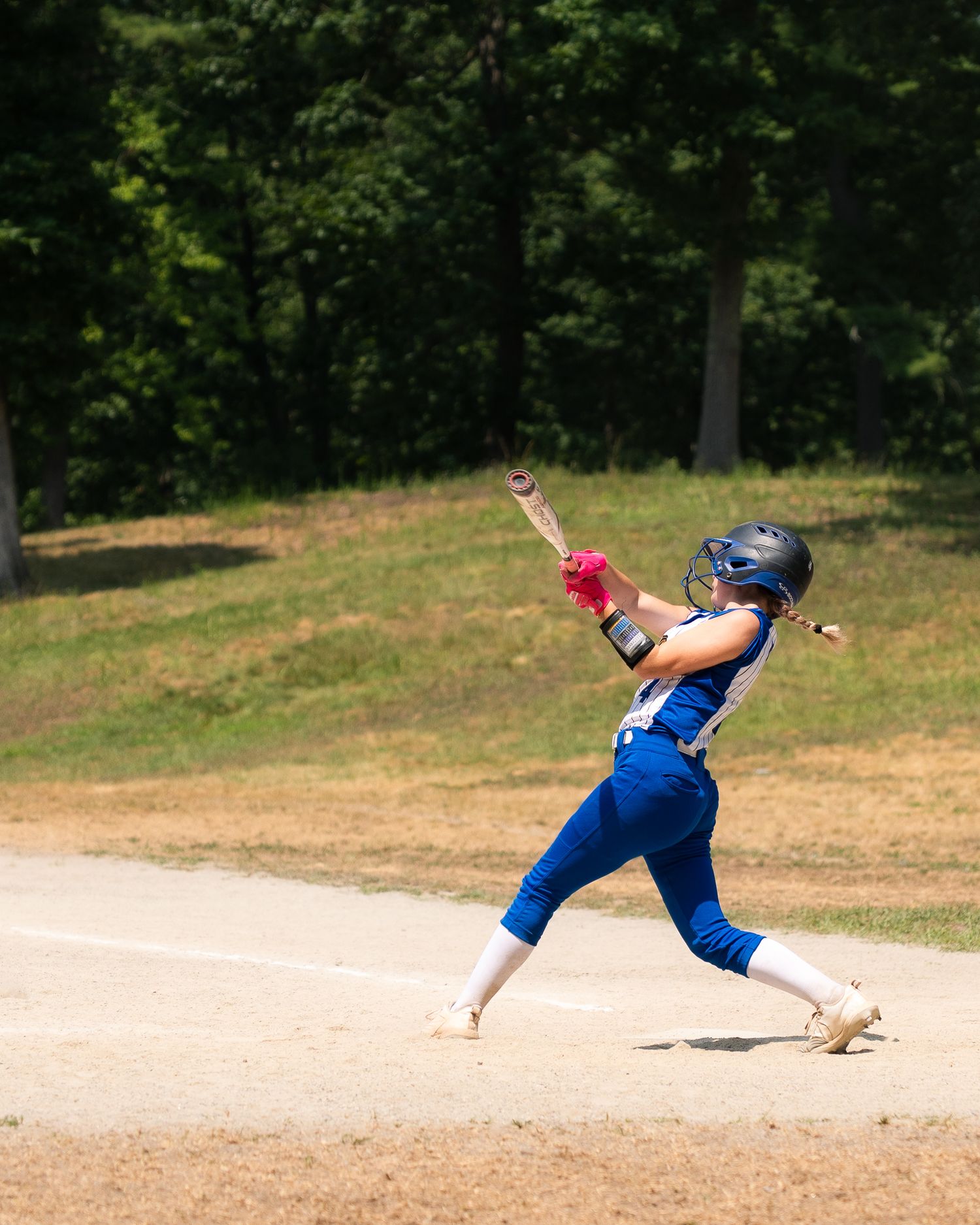 Sequential shots of a softball player diving and sliding on the field.