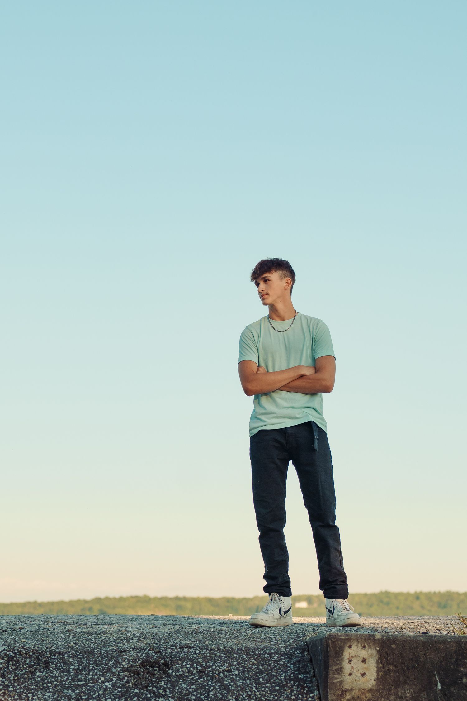 Environmental portraits on a concrete structure against soft blue sky at sunset.
