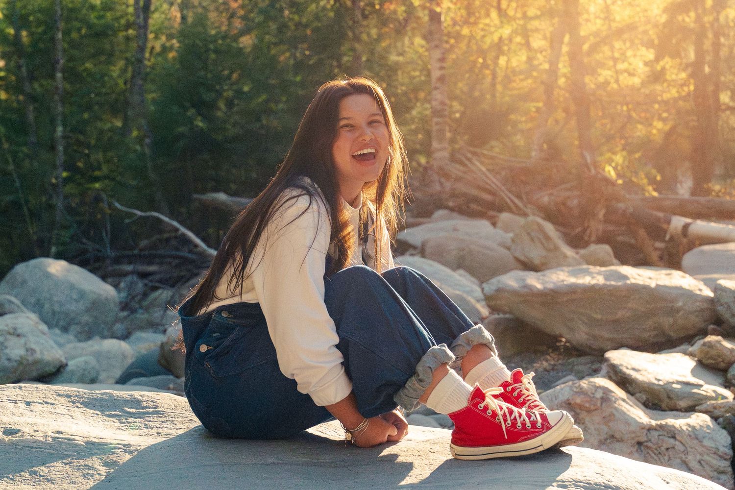 A series of lifestyle photos showing someone lounging on rocks near water during golden hour sunset.