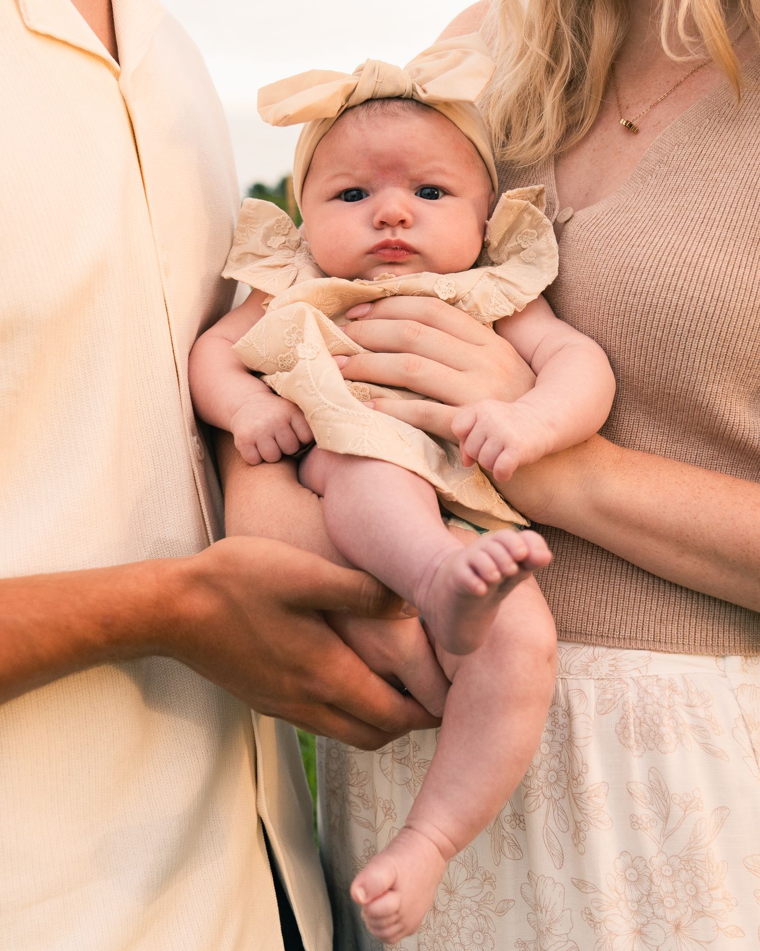 Close-up shots of parents holding and cuddling their infant baby.