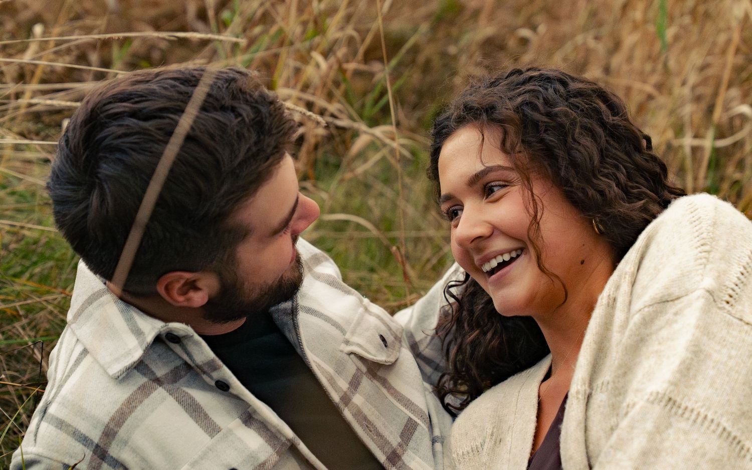 A series of candid romantic moments between a couple in a rustic outdoor setting.