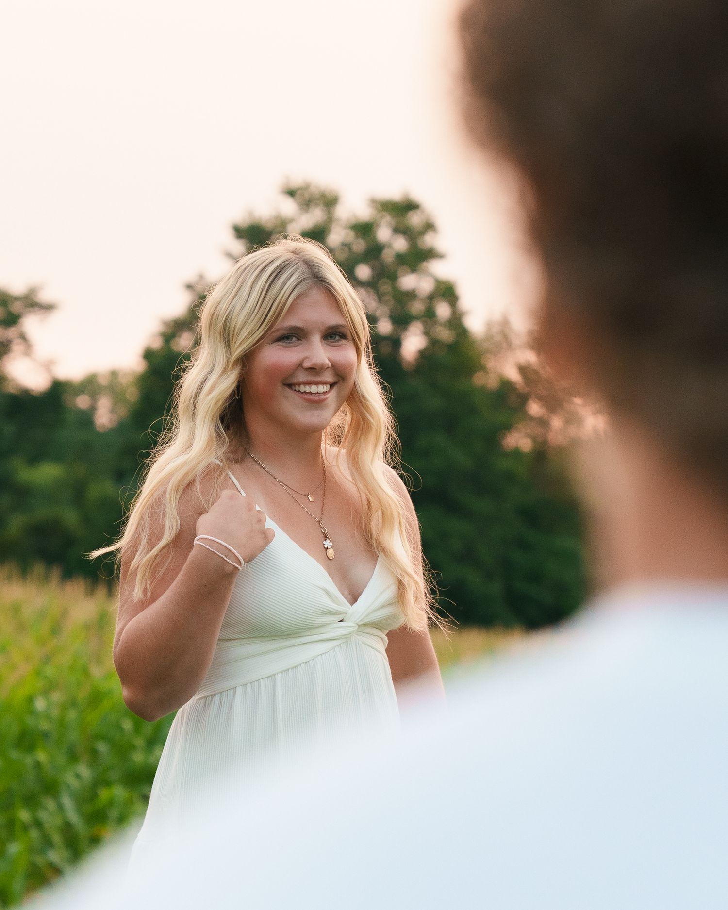 Golden hour photoshoot in a lush cornfield setting.