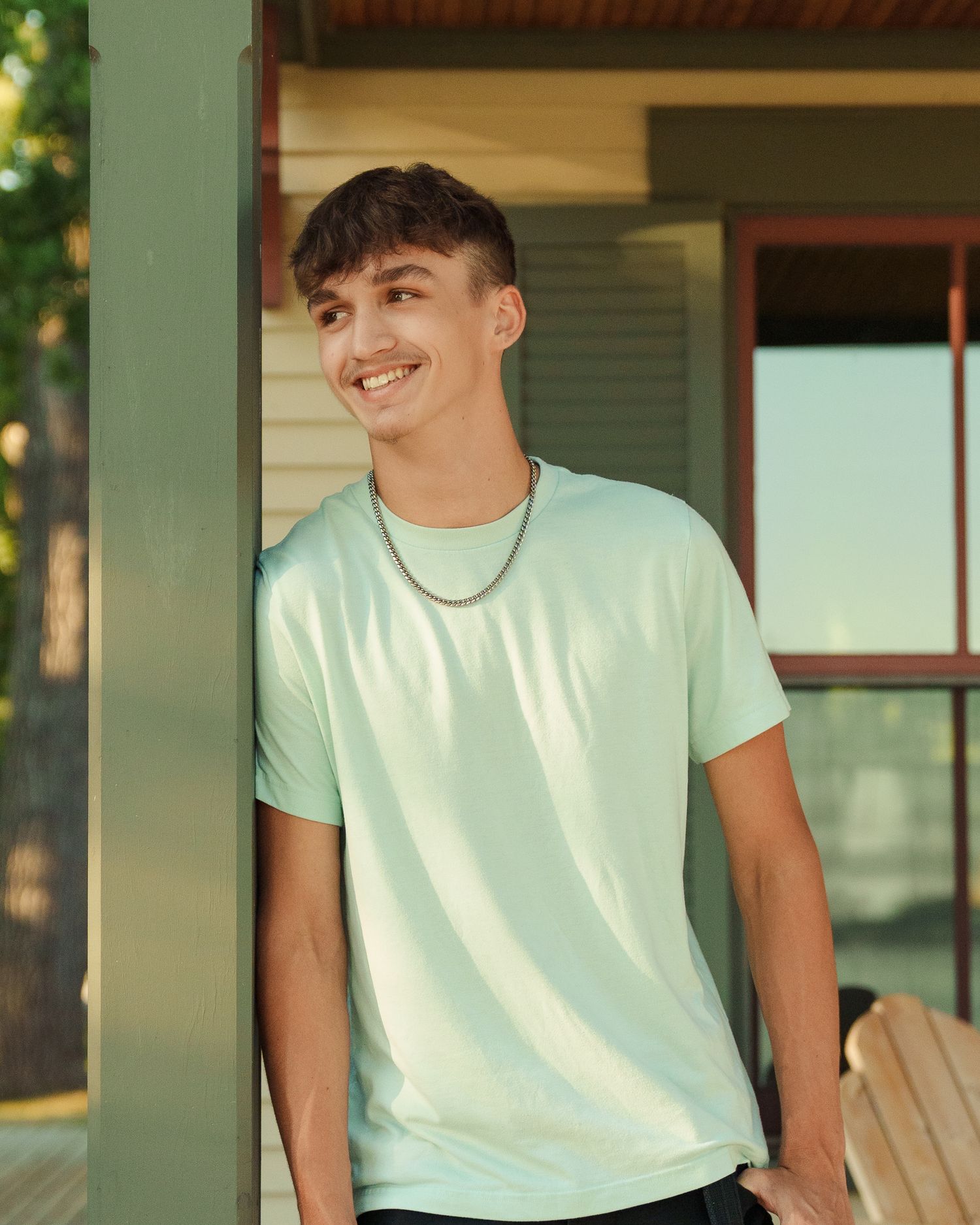 Summer portraits on a front porch featuring mint colored t-shirt and casual styling.