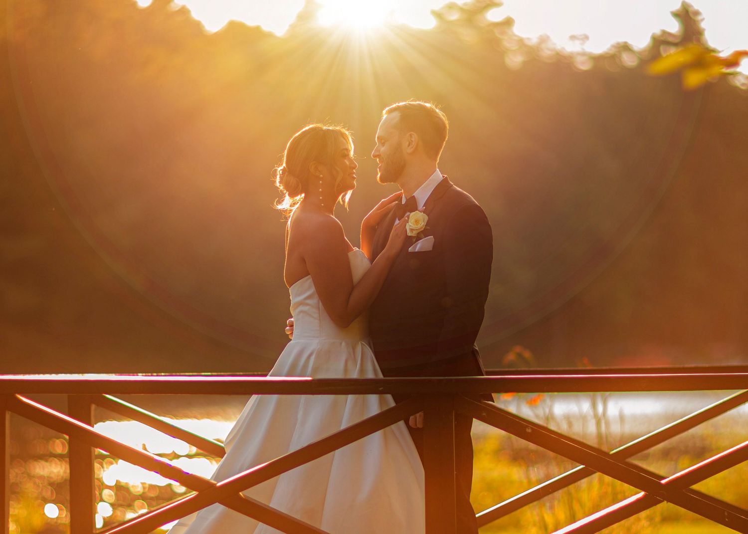 Bride and groom at sunset on bridge at Old Daley on Crooked Lake house in Averill Park NY