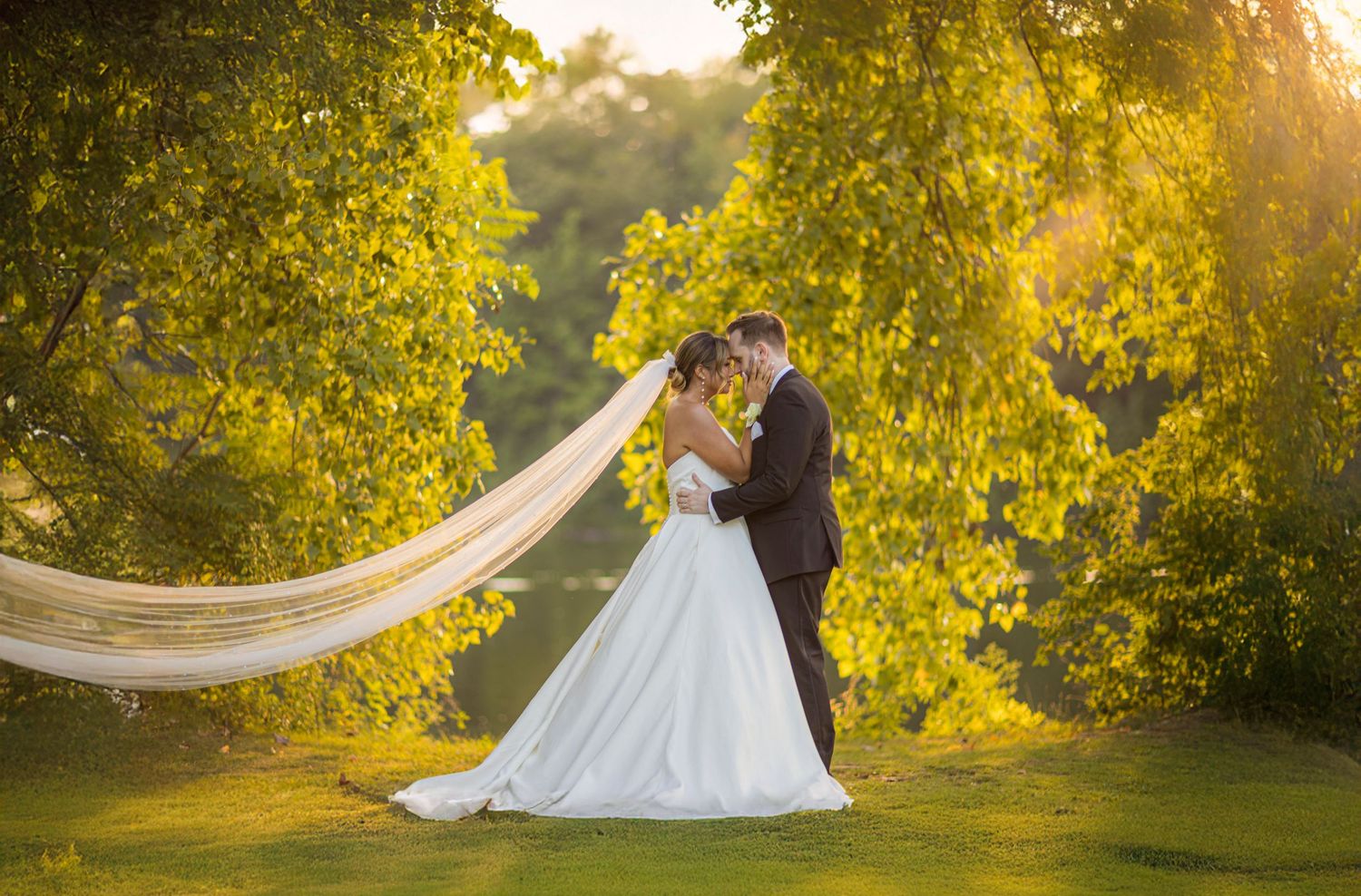 Old Daley Crooked Lake house wedding, bride and groom at sunset with long veil