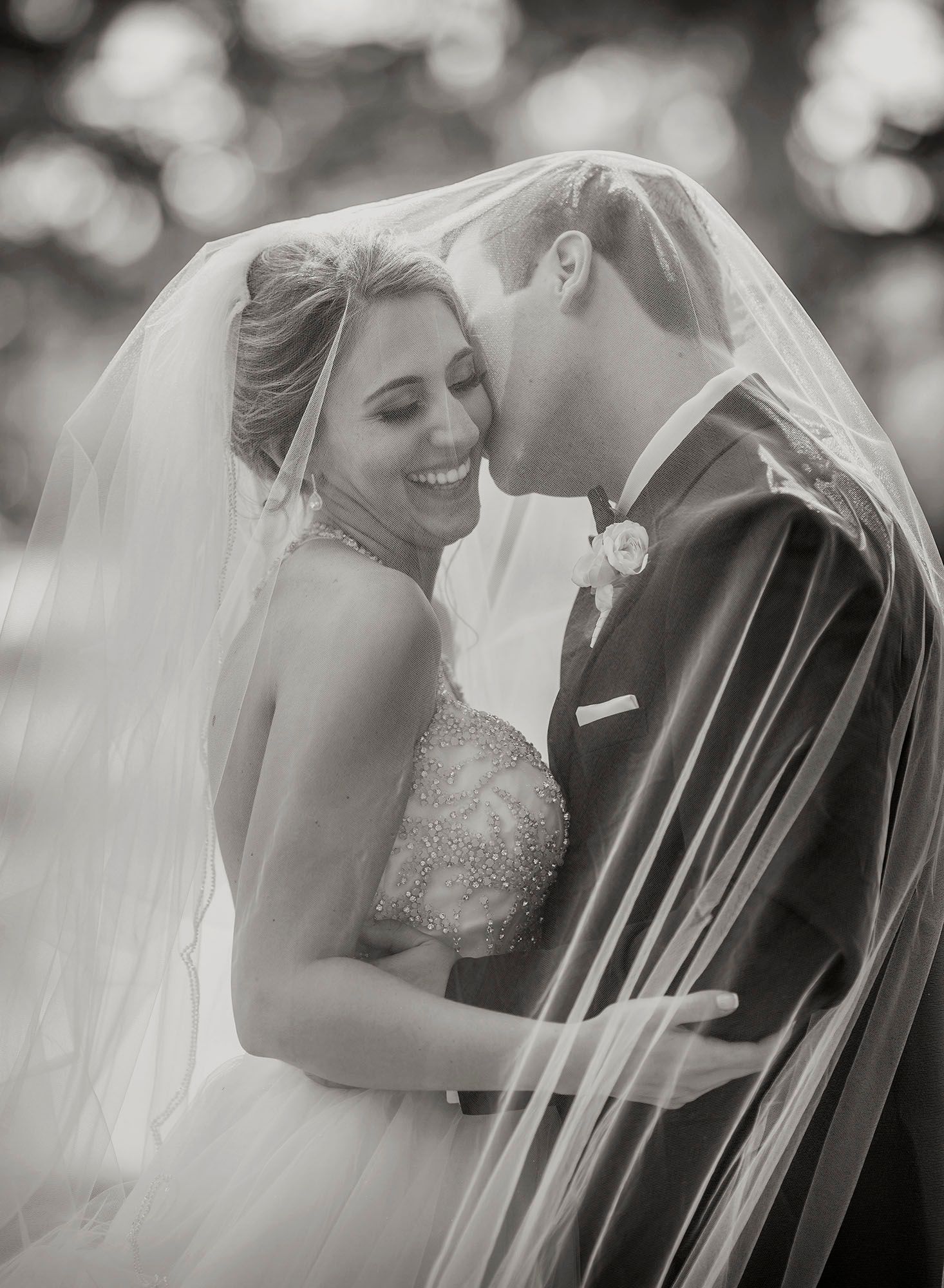 bride and groom under veil in black and white at Congress Park in Saratoga Springs NY