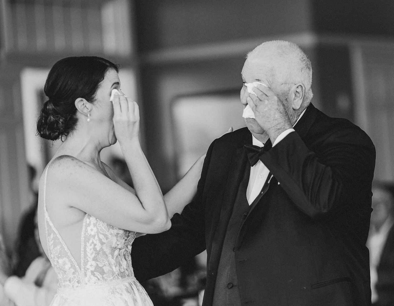 Bride and father wiping tears during father daughter dance. Black and white candid emotional photo. Albany NY wedding.