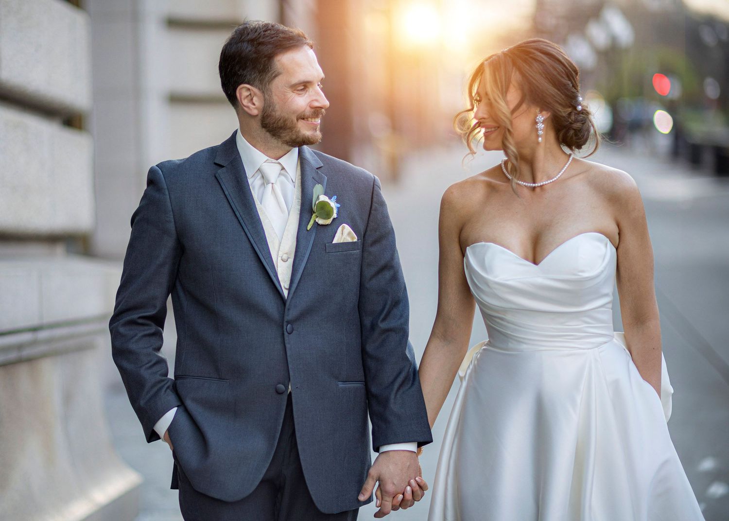 Bride and groom at sunset walking in downtown Albany NY outside of wedding venue The State Room