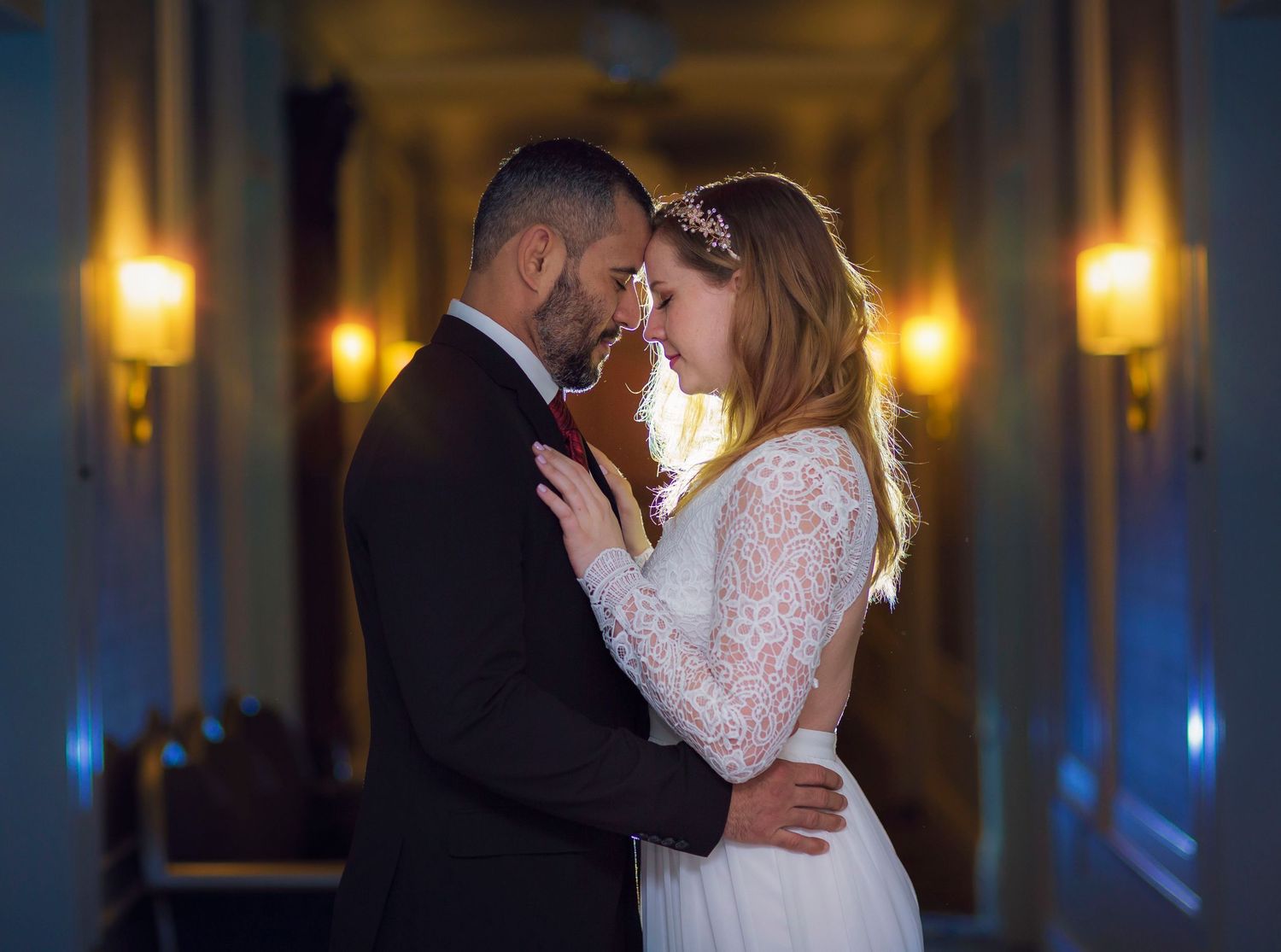 Bride and groom backlit in hallway at The Adelphi Hotel in Saratoga Springs NY