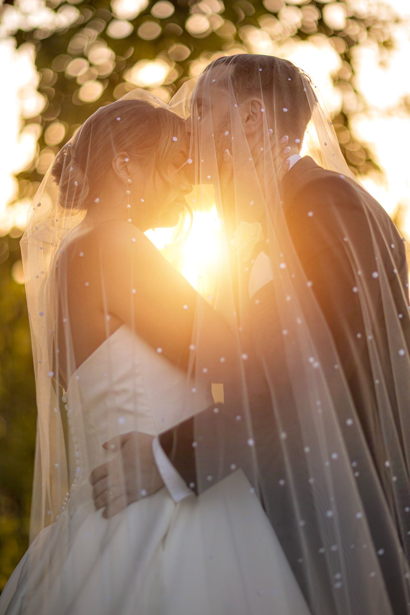 Sunset bride and groom under veil. Albany NY wedding photography. Old Daley Crooked Lake House