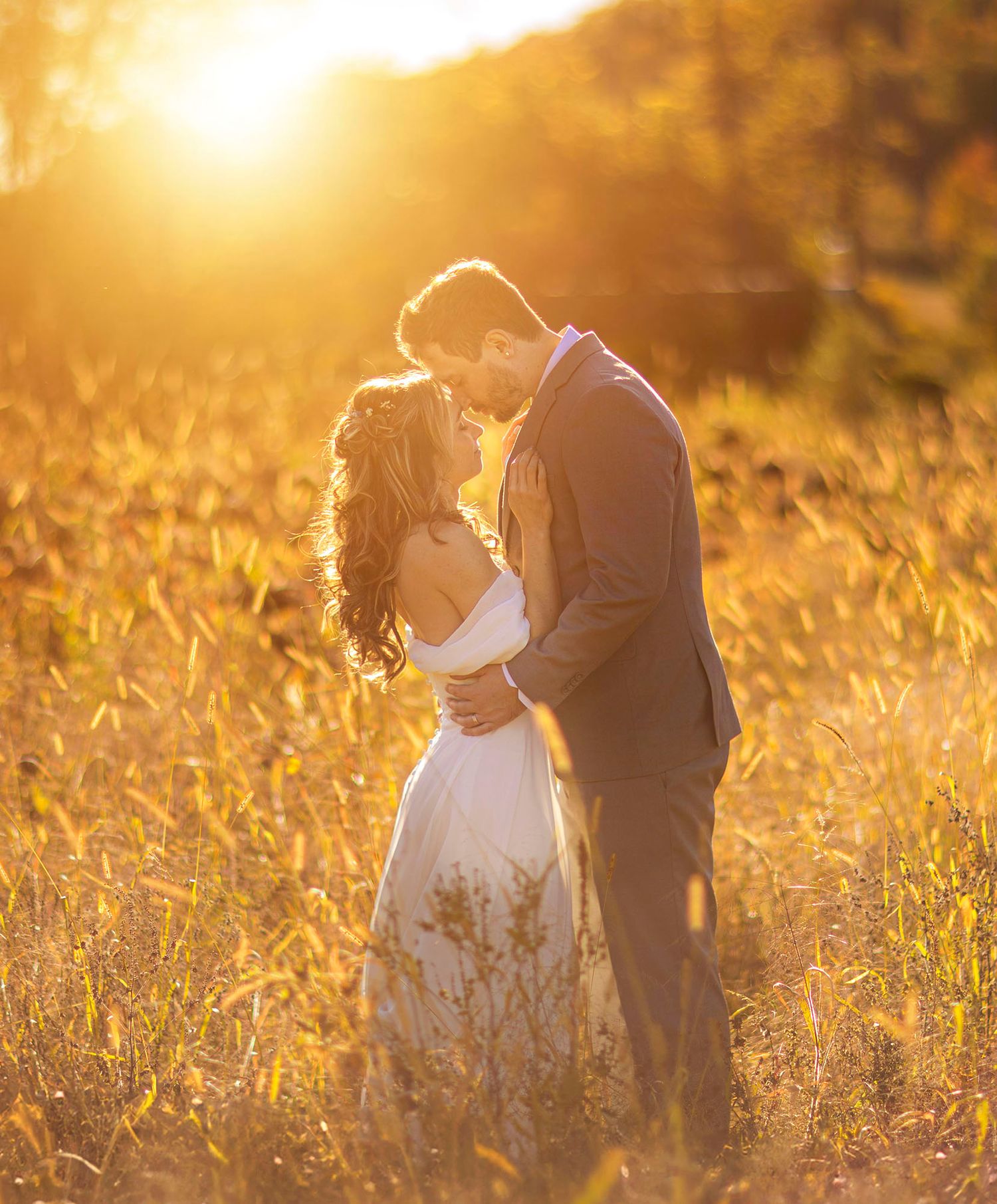Bride and groom at sunset in field at Gables and Gardens wedding and event barn in Granville NY