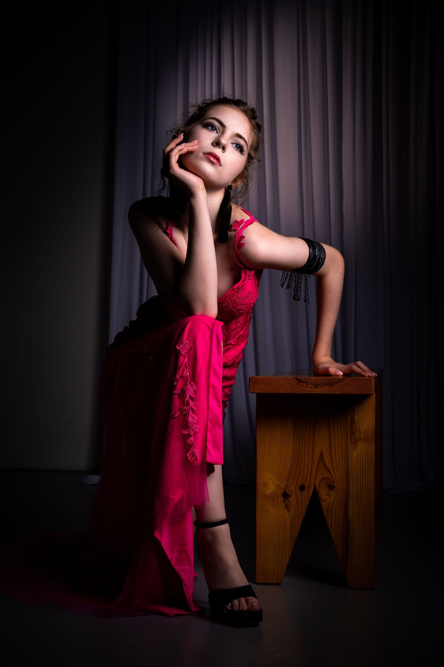 Artistic dance poses with pink fabric and wooden prop create dramatic studio portraits.