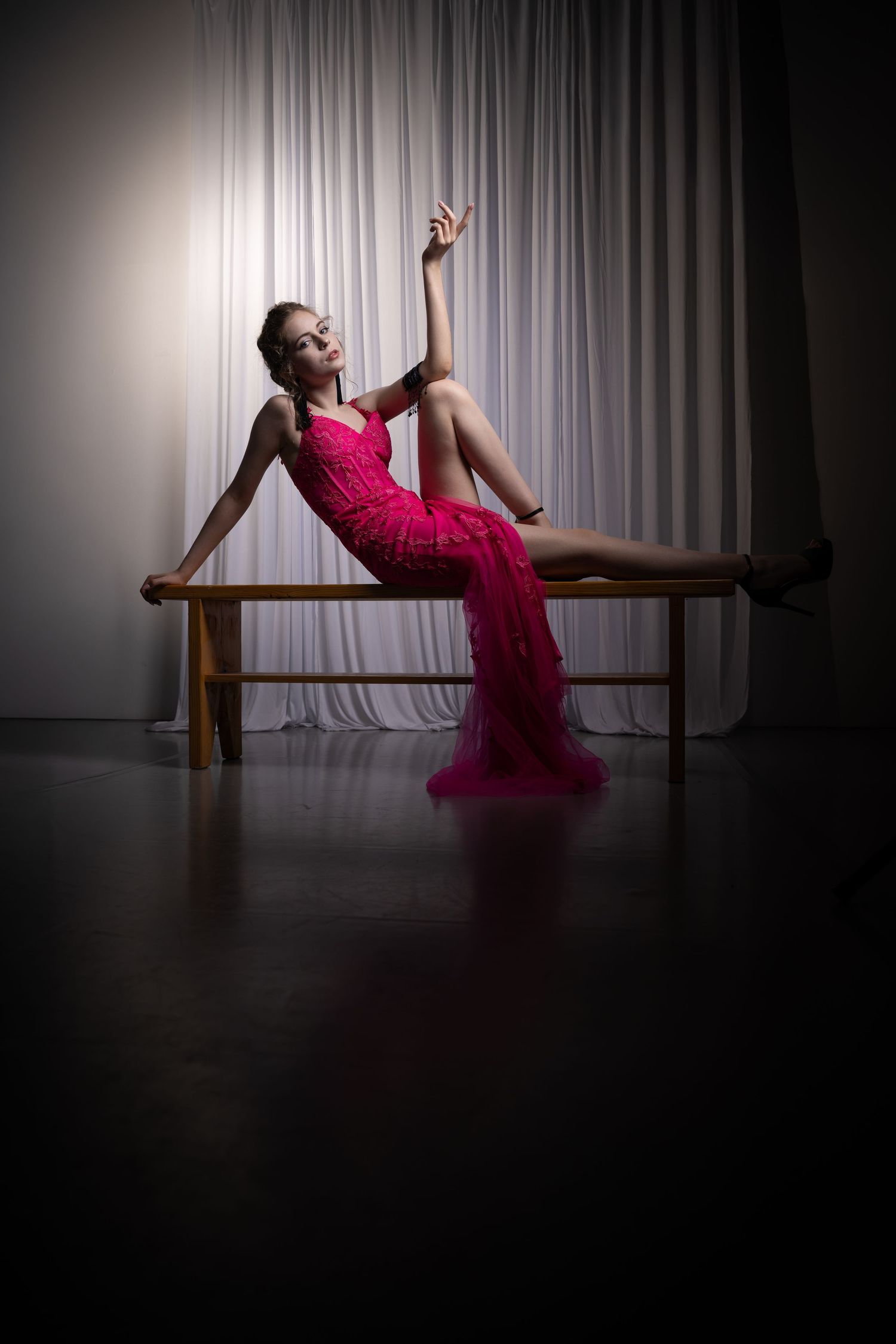 A series of artistic dance poses featuring flowing pink fabric against a moody studio backdrop.