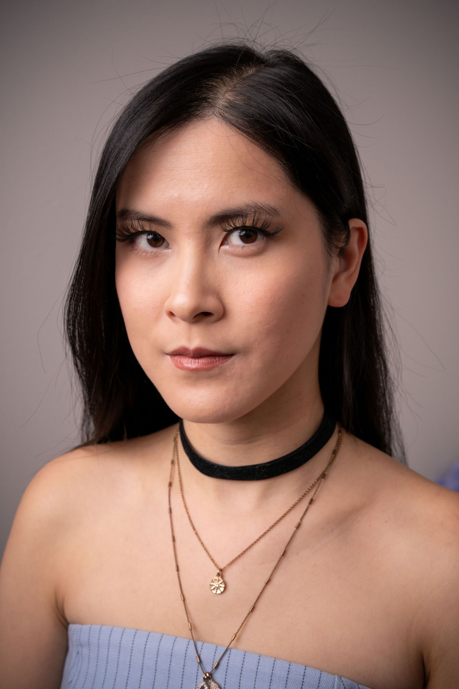 Portrait series featuring delicate jewelry and soft lighting against neutral background.