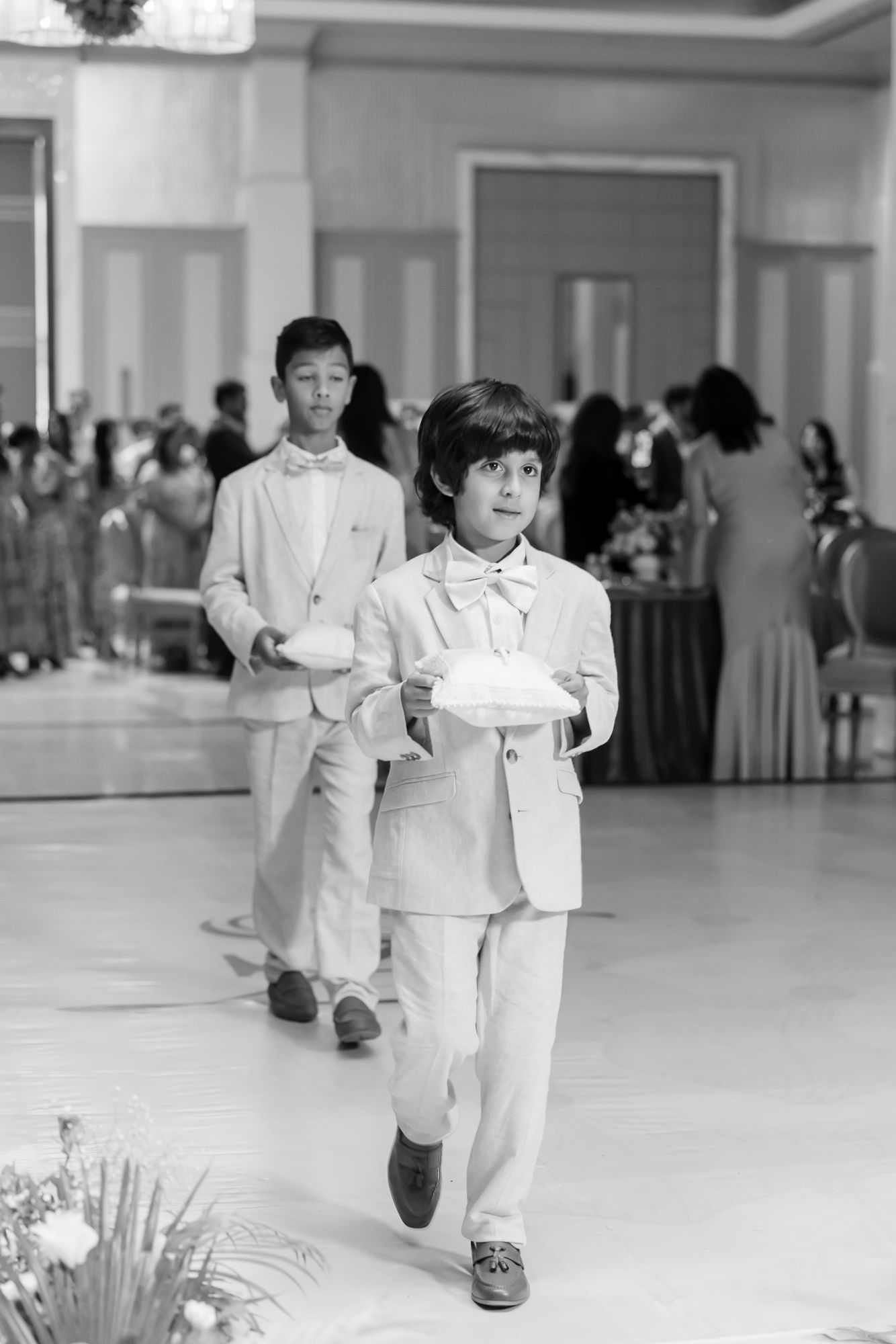 Flowerboyswalking down the aisle during Shorye and Leah's Christian wedding ceremony at Tivoli Chattarpur