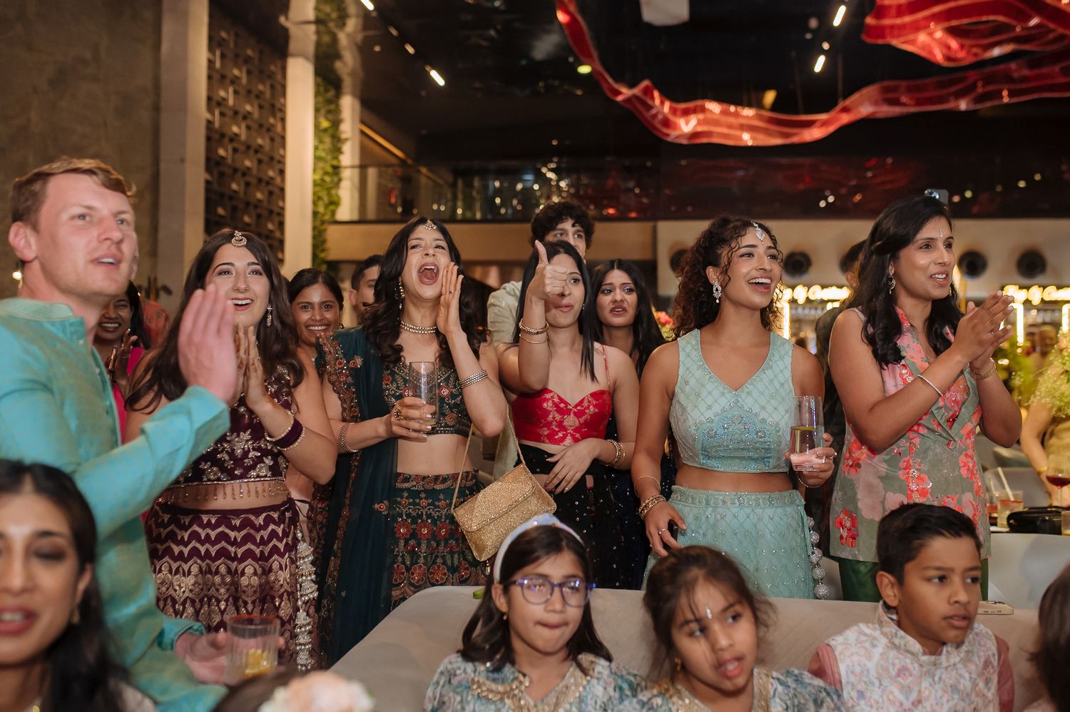 Wedding guests cheering during a Sangeet performance at Tivoli Chattarpur