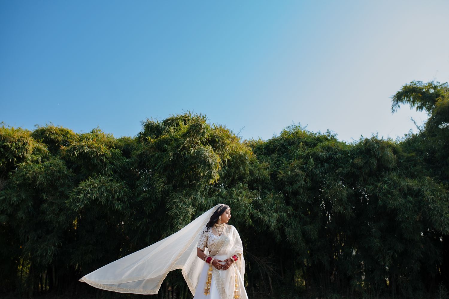 Elegant bridal portrait of Bride Itisha in an ivory lehenga for an intimate Indo-Norwegian wedding in Forest Hill, Chandigarh