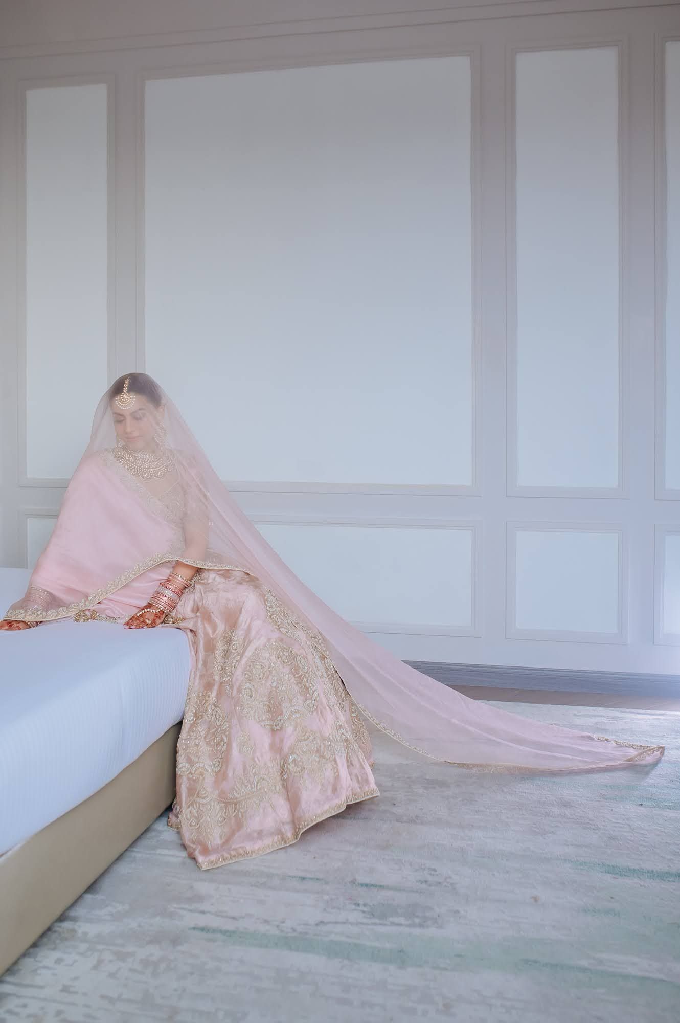 Bride Leah embracing a soft pastel bridal palette for her Punjabi wedding at Tivoli Chattarpur