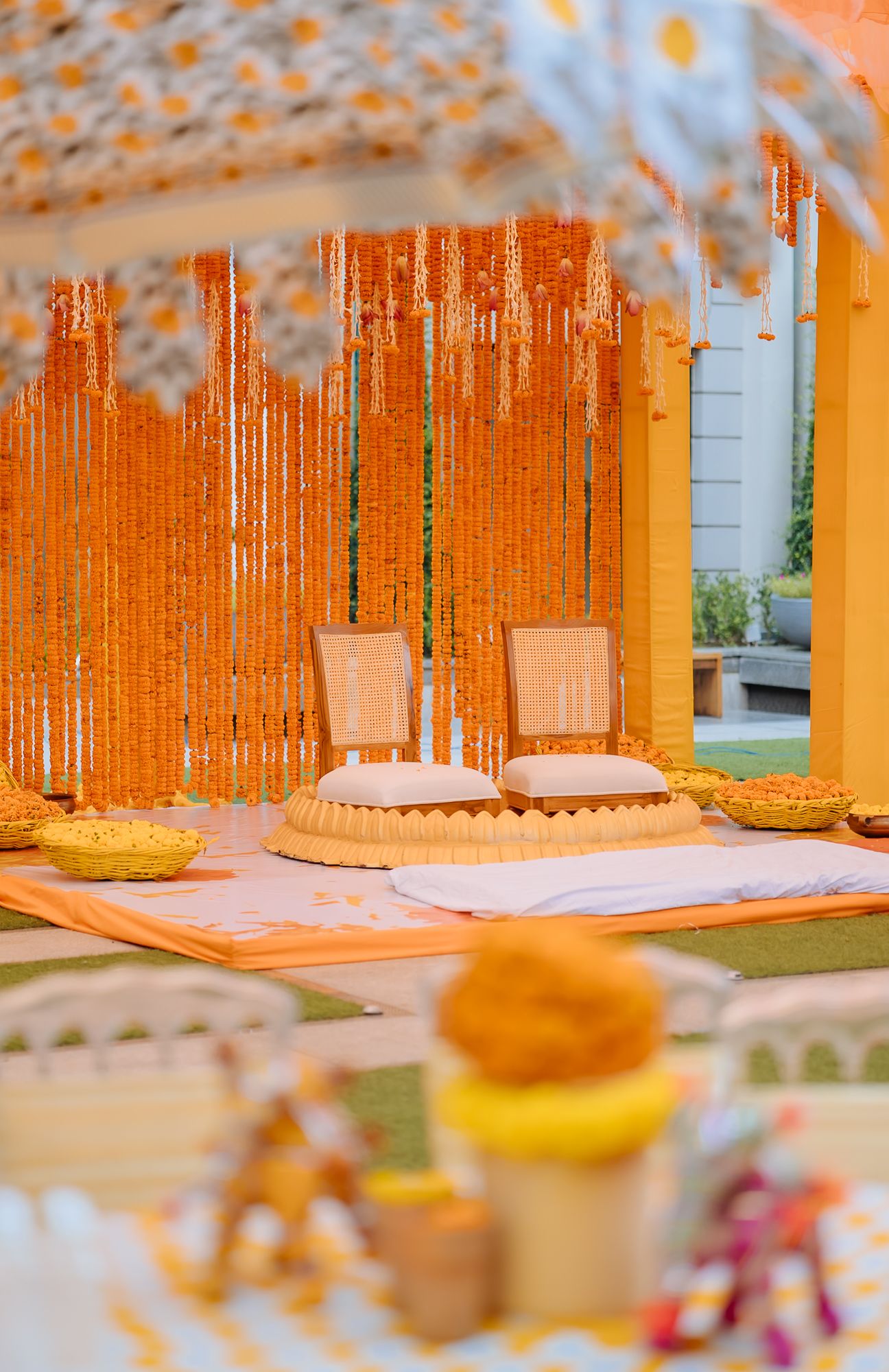 Colourful orange and yellow marigold decor for a traditional Indian wedding Haldi at Tivoli Chattarpur