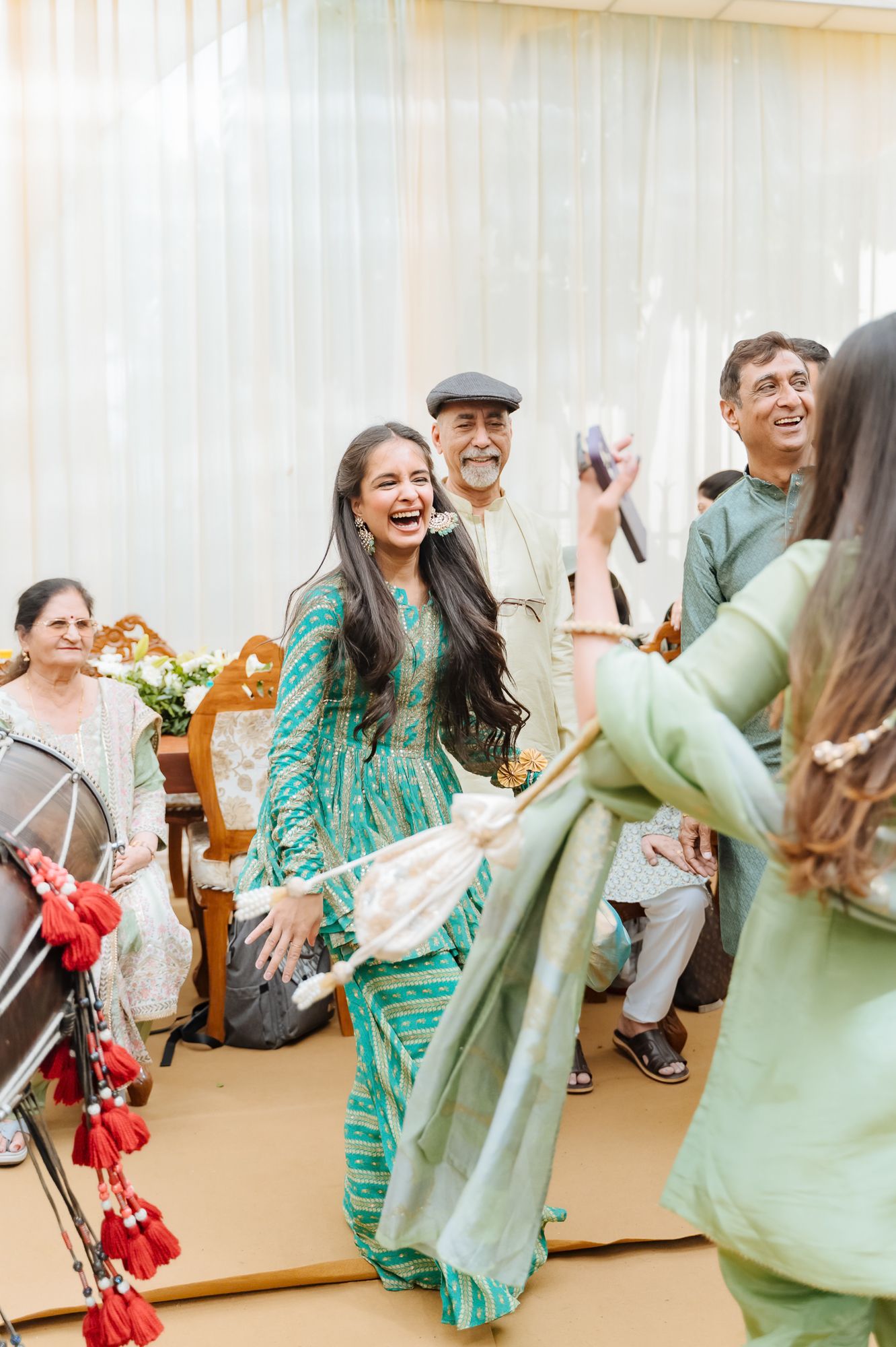 Family dancing together during the Mehendi celebrations at an Intimate home wedding moments before the wedding festivities begin