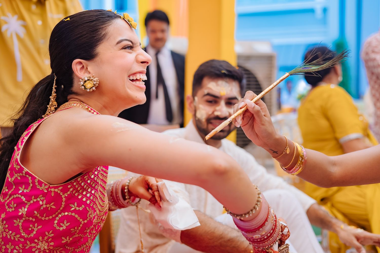 Shorye and Leah covered in haldi during their wedding celebration at Tivoli Chattarpur