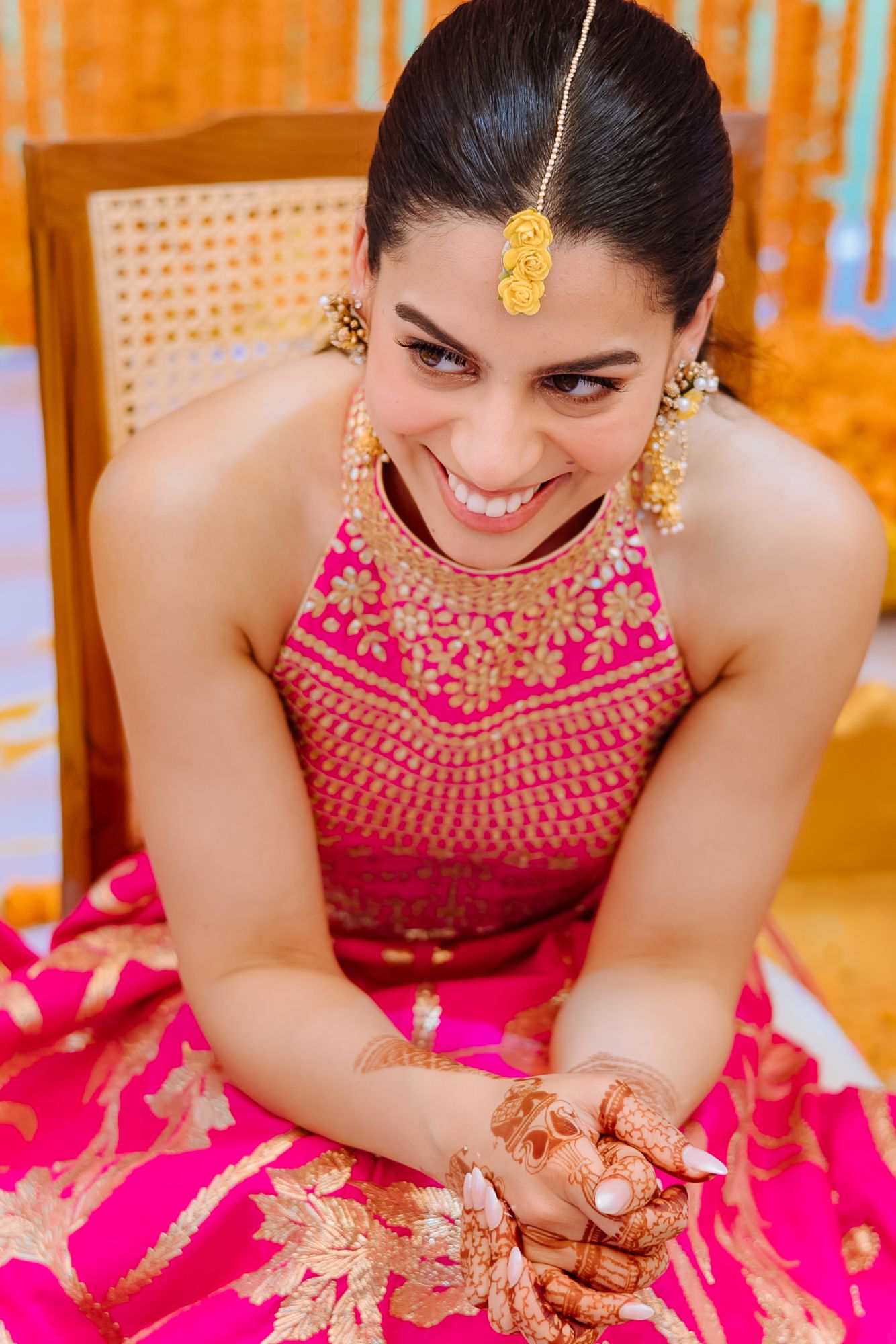 Bride-to-be Leah being adorned with her bridal chooda as part of the Punjabi wedding traditions at Tivoli Chattarpur