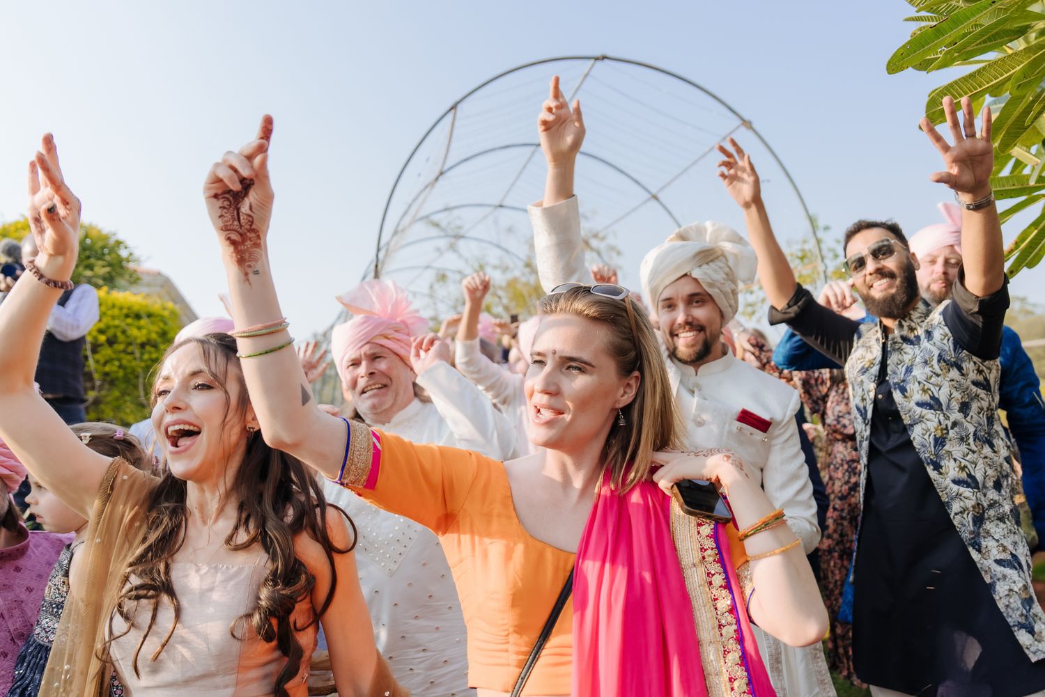 Joyful baraat with the groom's Norwegian family celebrating in Indian attire for an Indo-Norwegian fusion wedding in Forest Hill Chandigarh