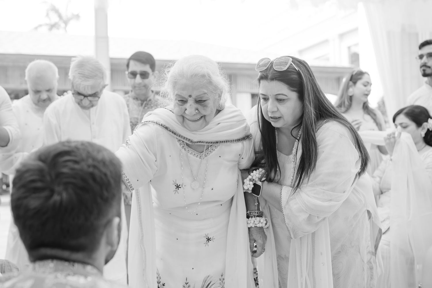 Guests blessing Shorye and Leah while applying haldi during their wedding celebration at Tivoli Chattarpur