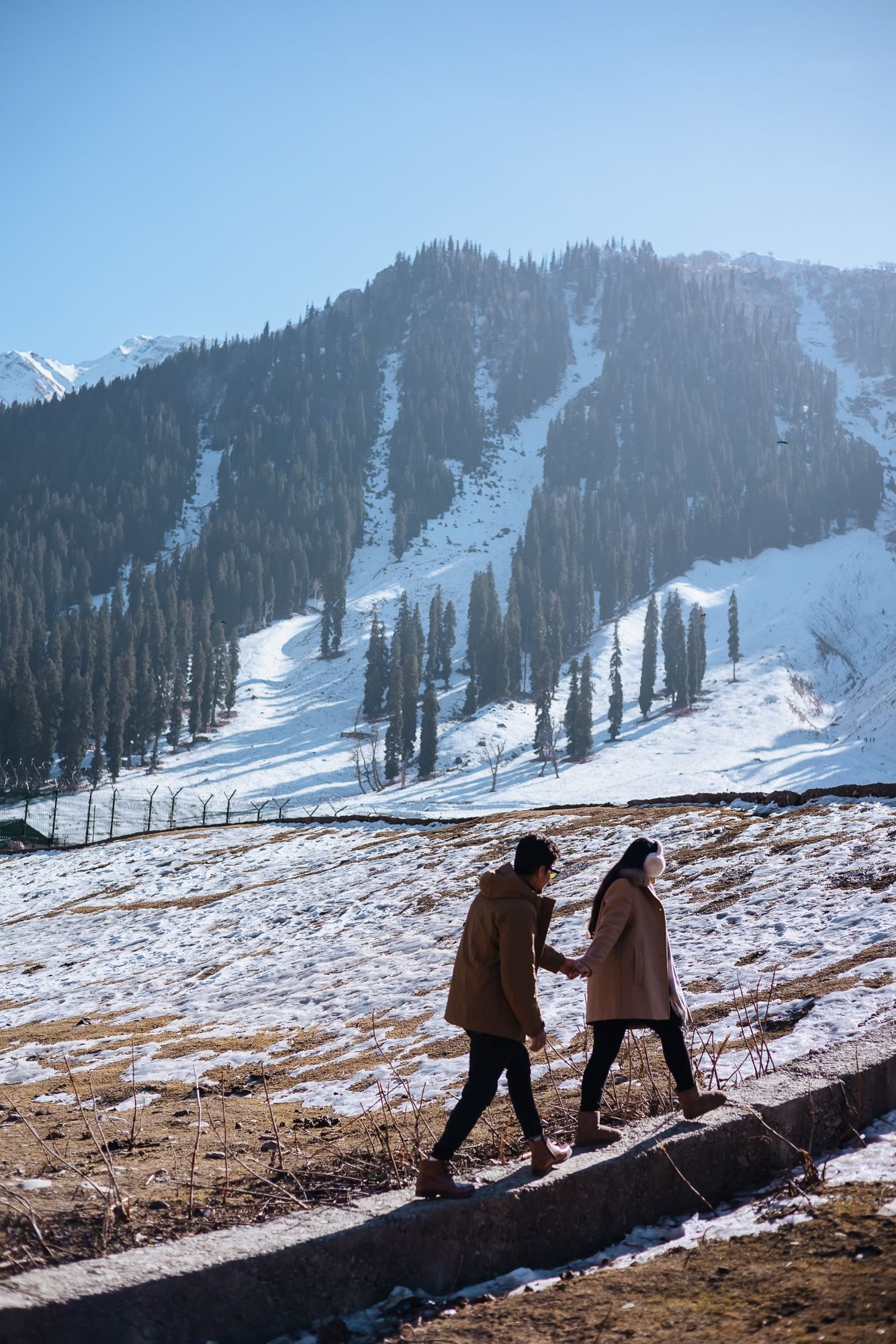 Pre-wedding couple walking hand in hand in Srinagar, nostalgic editorial style