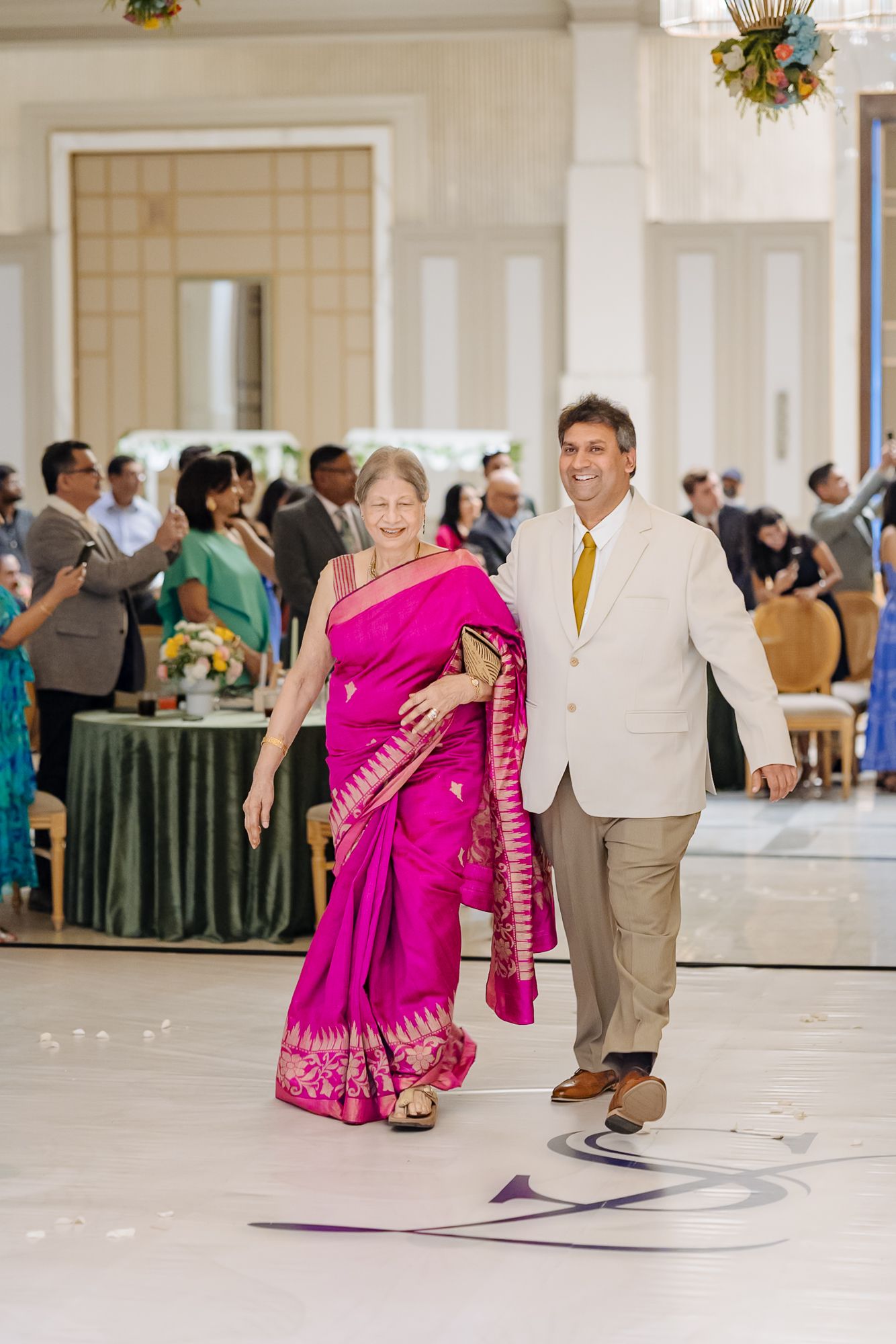 Bridesmaids walking down the aisle during Shorye and Leah's Christian wedding ceremony at Tivoli Chattarpur