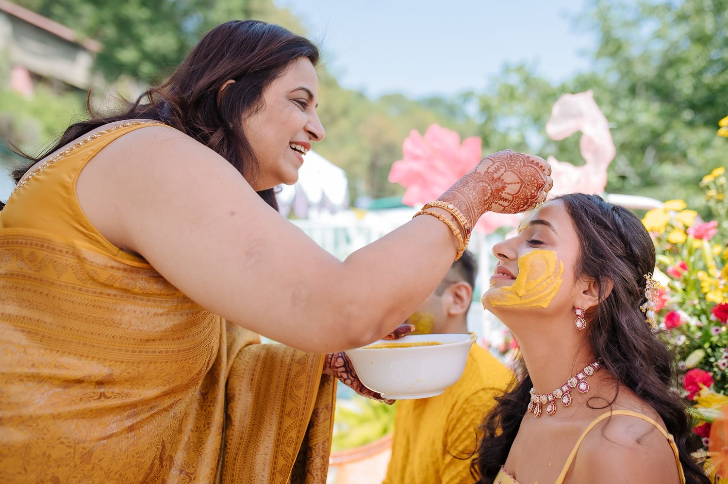 Colorful and candid Haldi moments captured by Fine-art and candid Indian wedding photography and films team Beginnings For You.
