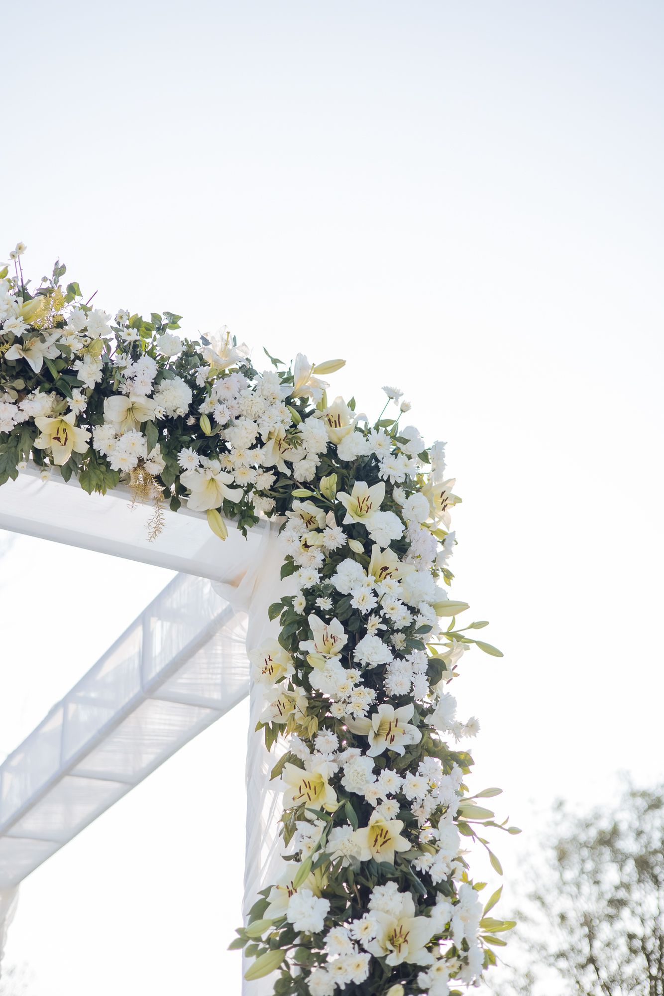 Minimal white floral mandap at Forest Hill for an intimate Indo-Norwegian wedding in Forest Hill, Chandigarh