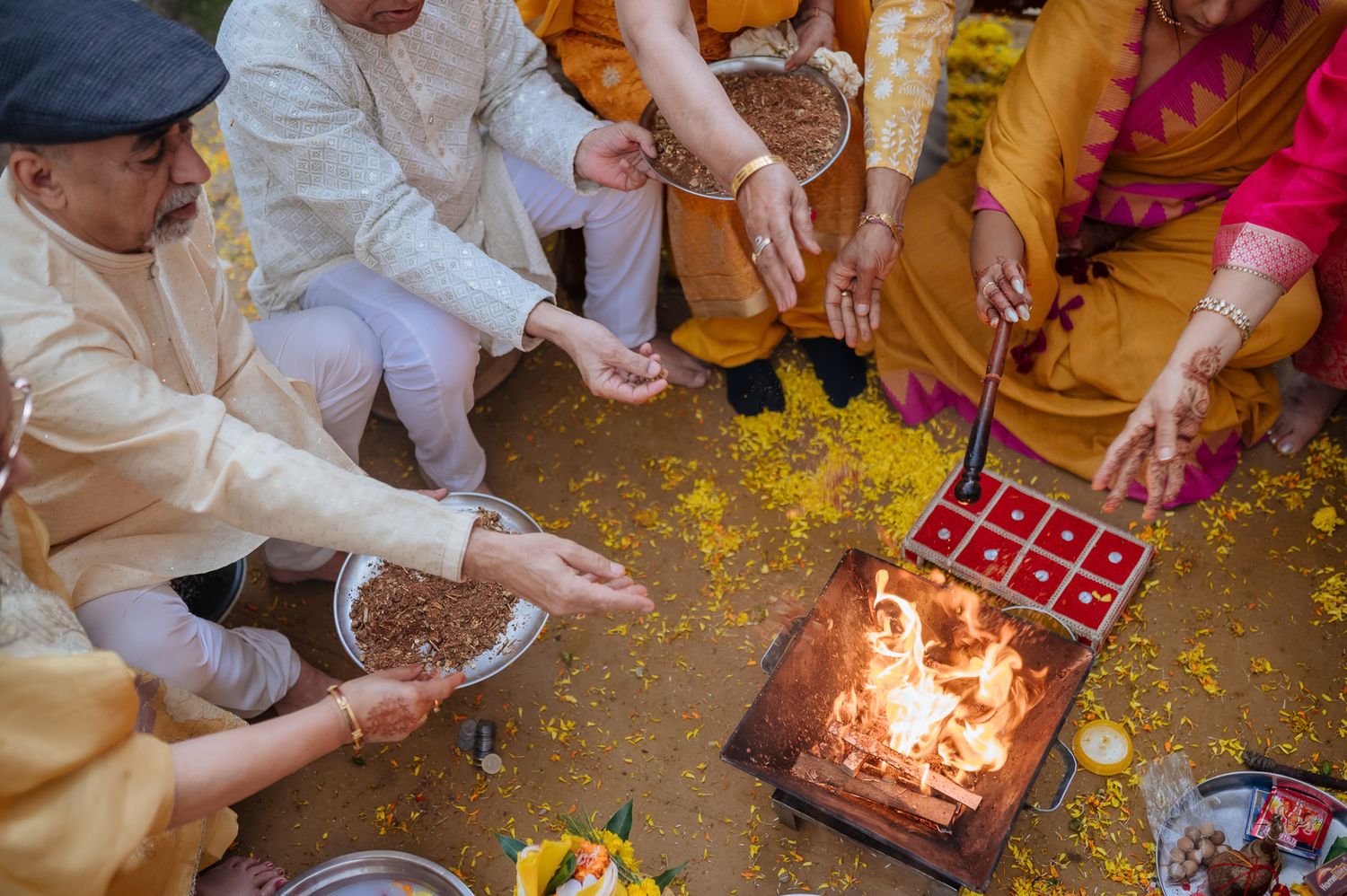 Family blessing the bride during the Punjabi Chooda ceremony during her indo-norwegian wedding in Chandigarh