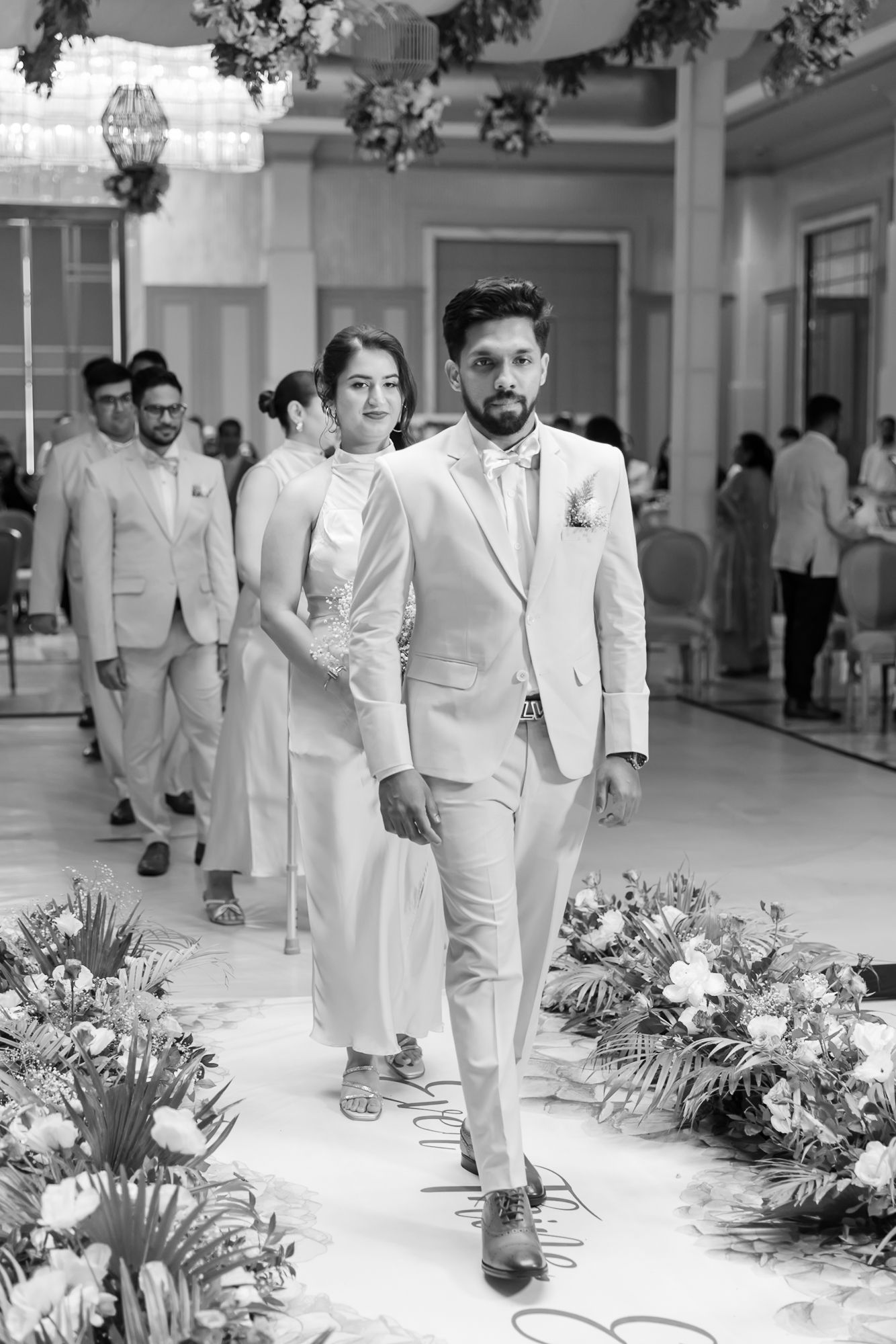 Groom Briddal Party walking down the aisle with his parents during her Christian wedding ceremony at Tivoli Chattarpur