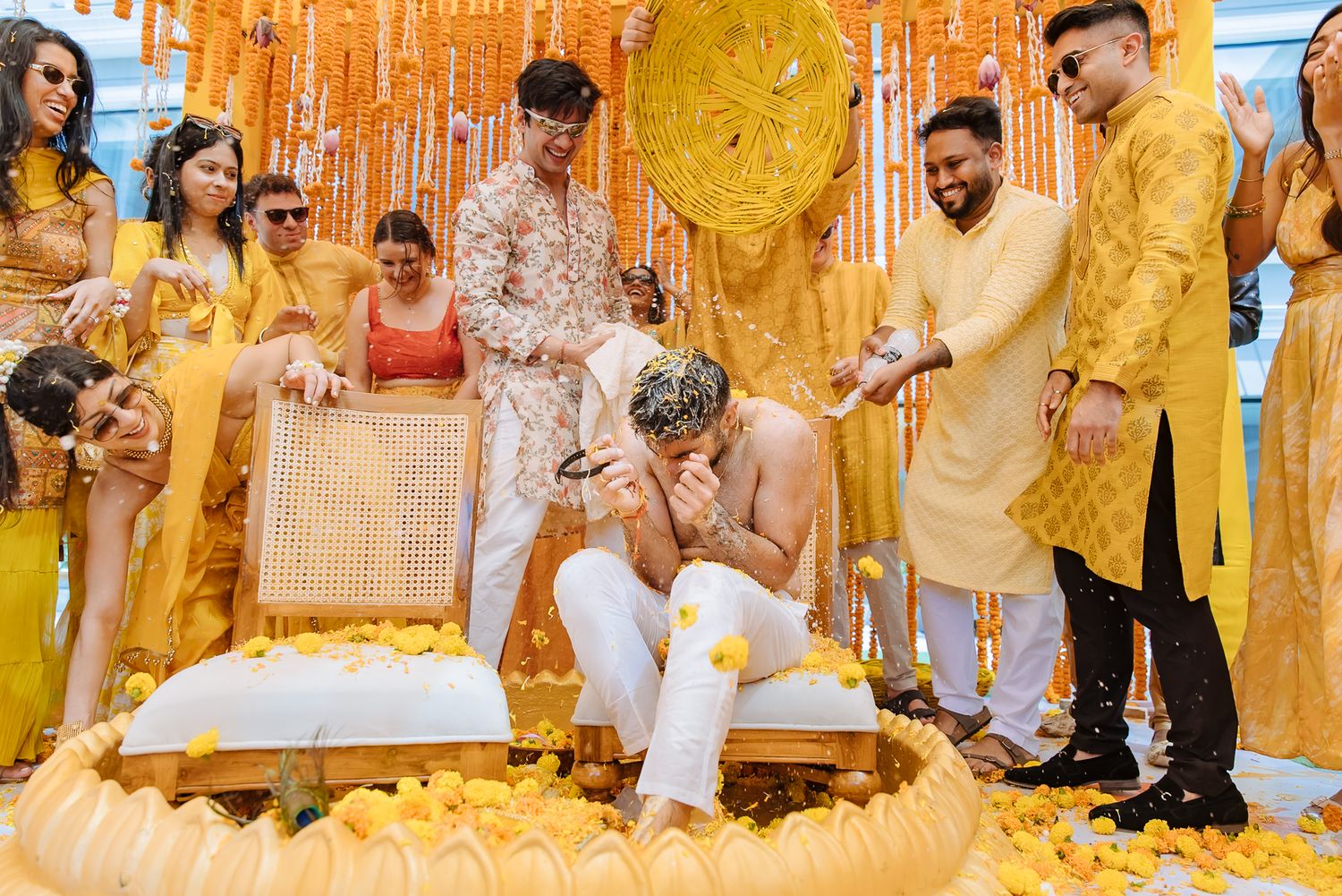 Friends and family joining in the playful kurta tearing ritual at Shorye and Leah’s Haldi at Tivoli Chattarpur