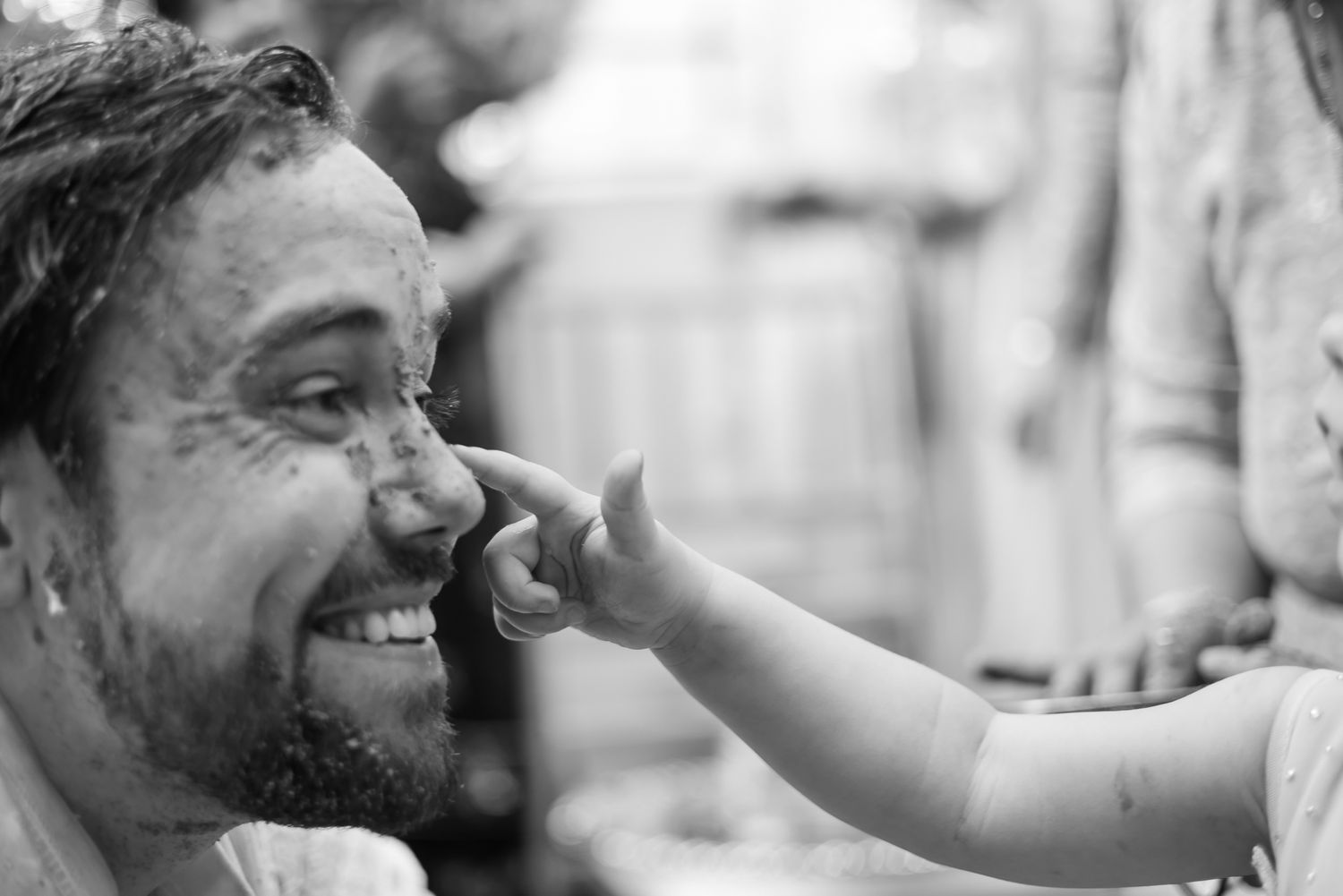 Bride and groom covered in turmeric during an Indo-Norwegian wedding and Family applying Haldi to the bride during a joyful wedding ritual