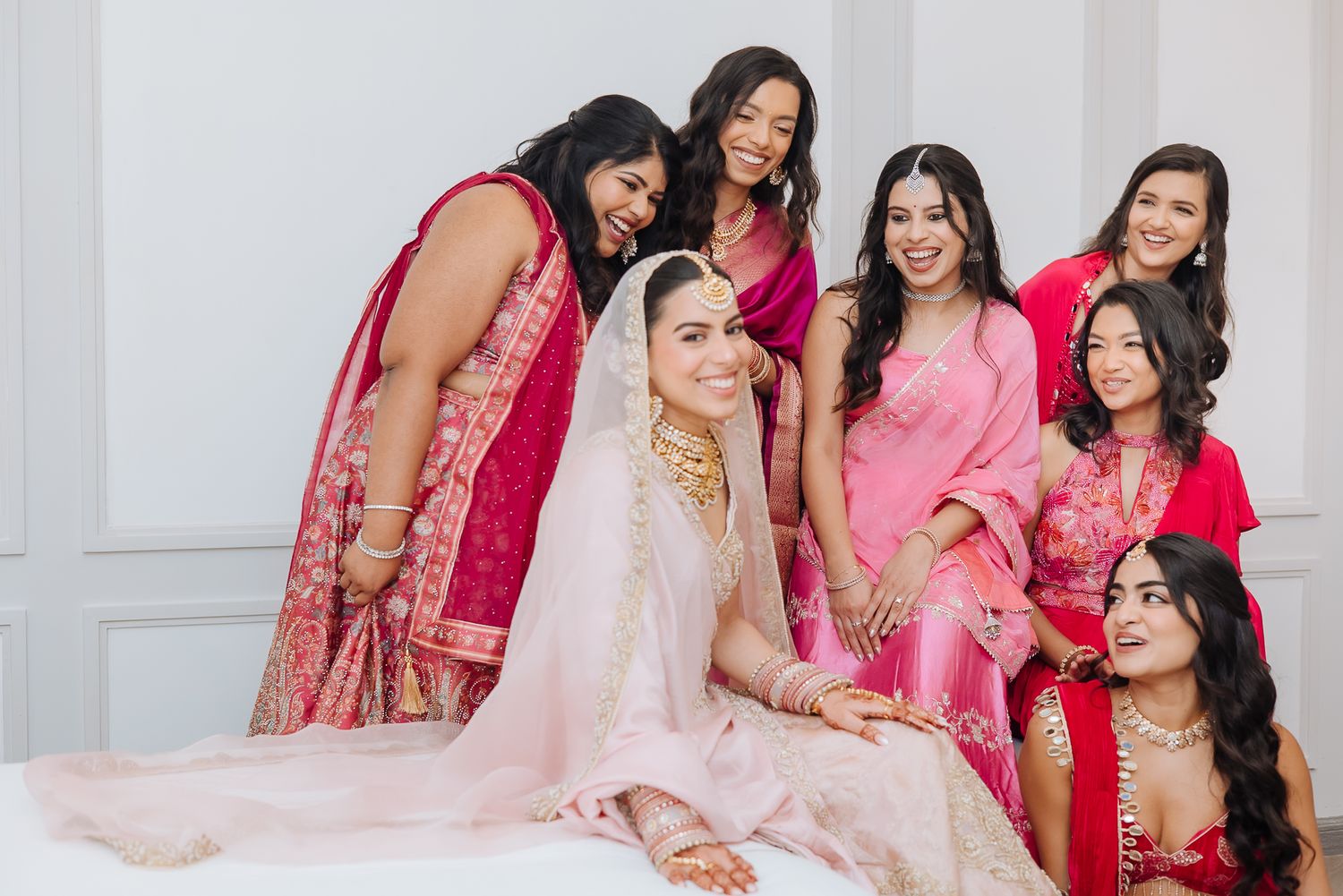 Leah’s radiant bridal portrait with her bridesmaids in shades of pink at Tivoli Chattarpur