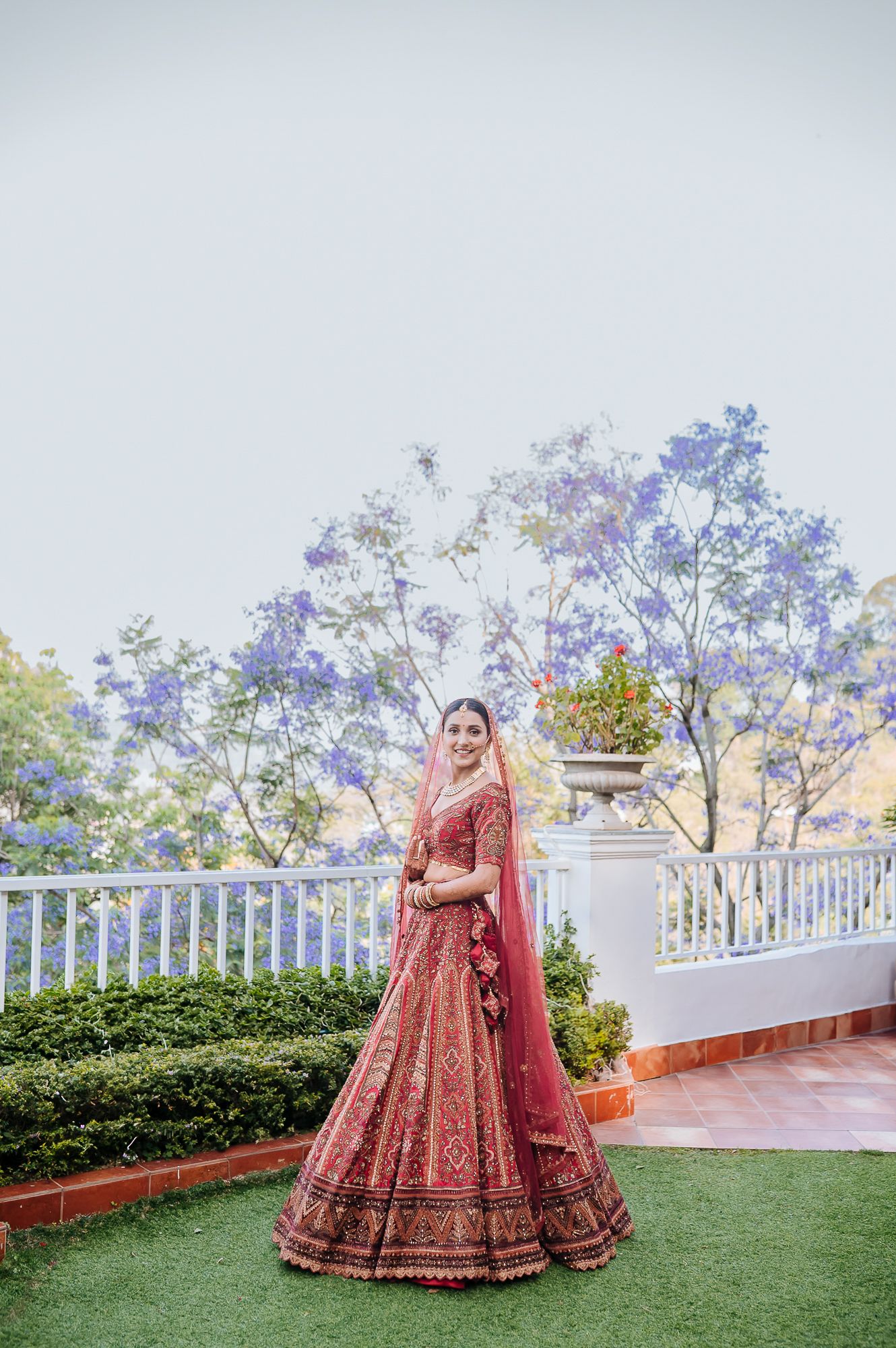 Indian bride in maroon lehenga with fine-art portraits for an intimate wedding of 30 people wedding in the hills at Daleside Manor, Kasauli