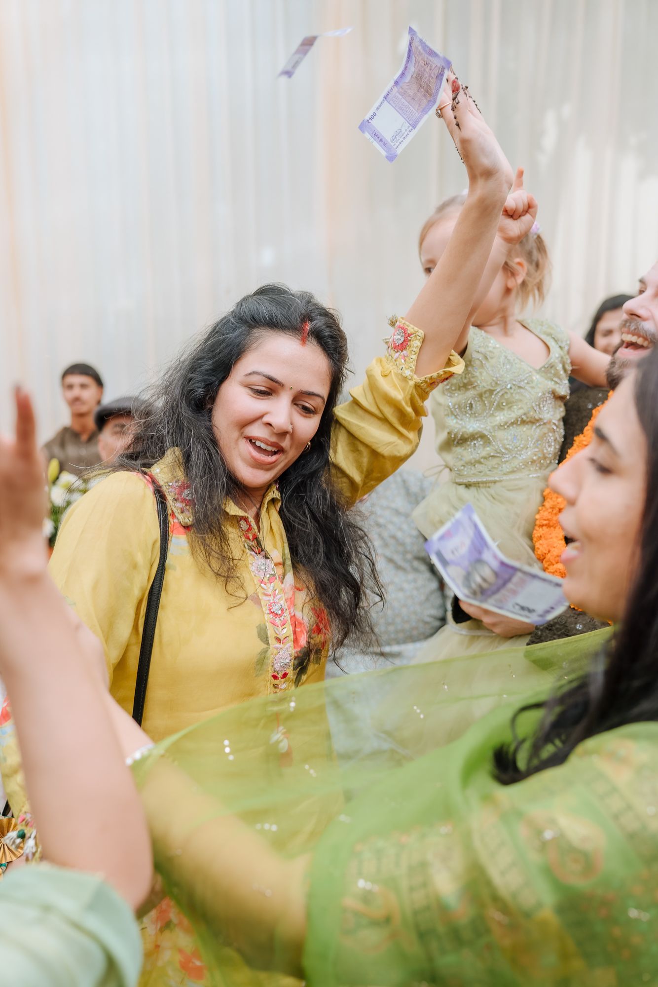 Family dancing together during the Mehendi celebrations at an Intimate home wedding moments before the wedding festivities begin