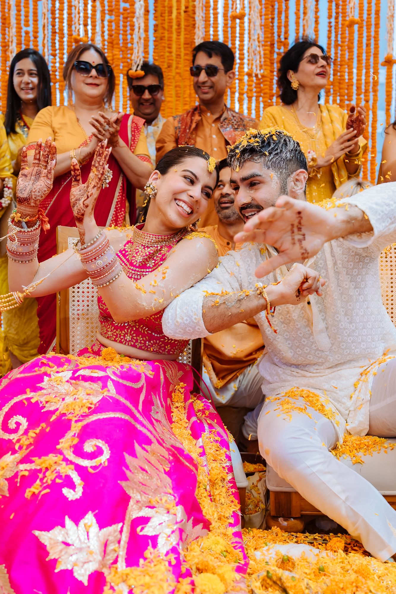 Colourful flower petals raining over Shorye and Leah during the Haldi at Tivoli Chattarpur