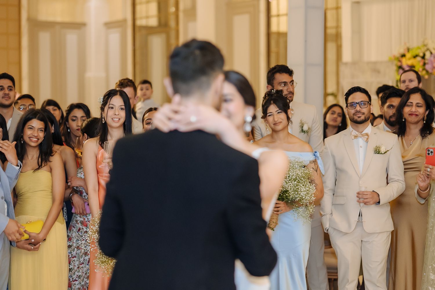 Newlyweds Shorye and Leah enjoying their first dance surrounded by loved ones, after the christian wedding ceremony at Tivoli Chattarpur
