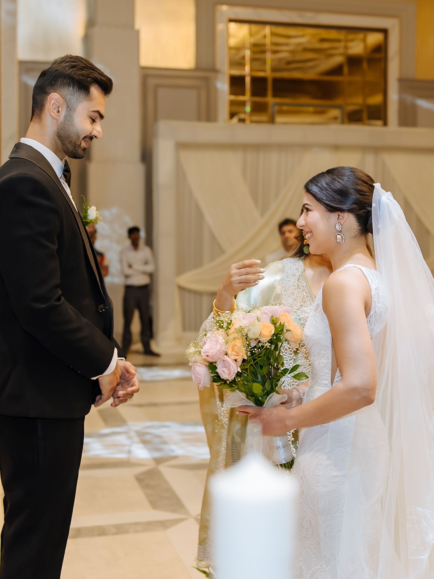 Leah walking down the aisle with her mother during her Christian wedding ceremony at Tivoli Chattarpur