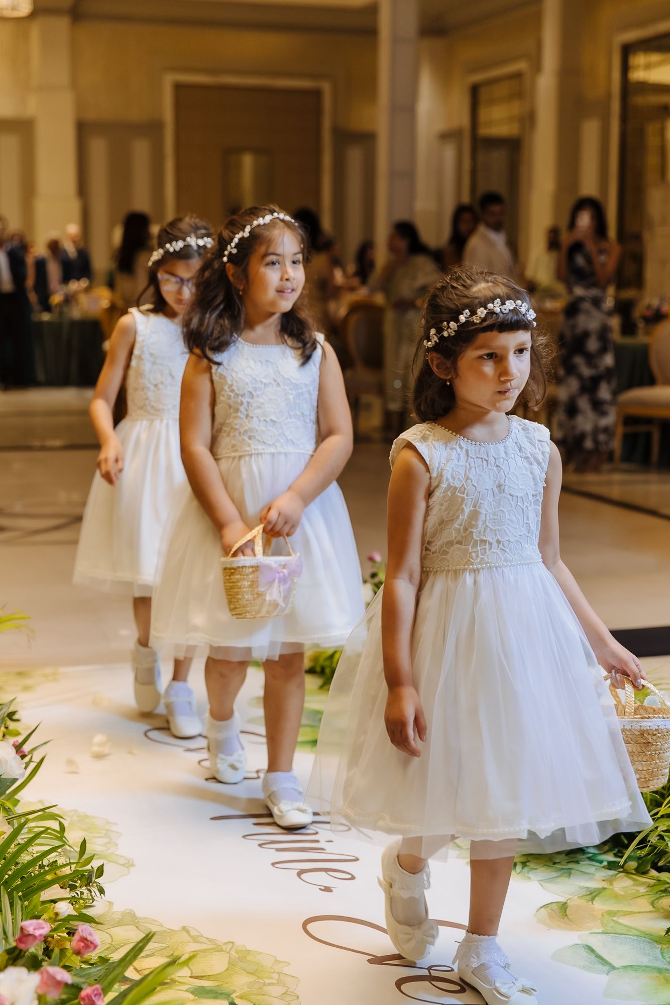 Flowergirls walking down the aisle during Shorye and Leah's Christian wedding ceremony at Tivoli Chattarpur