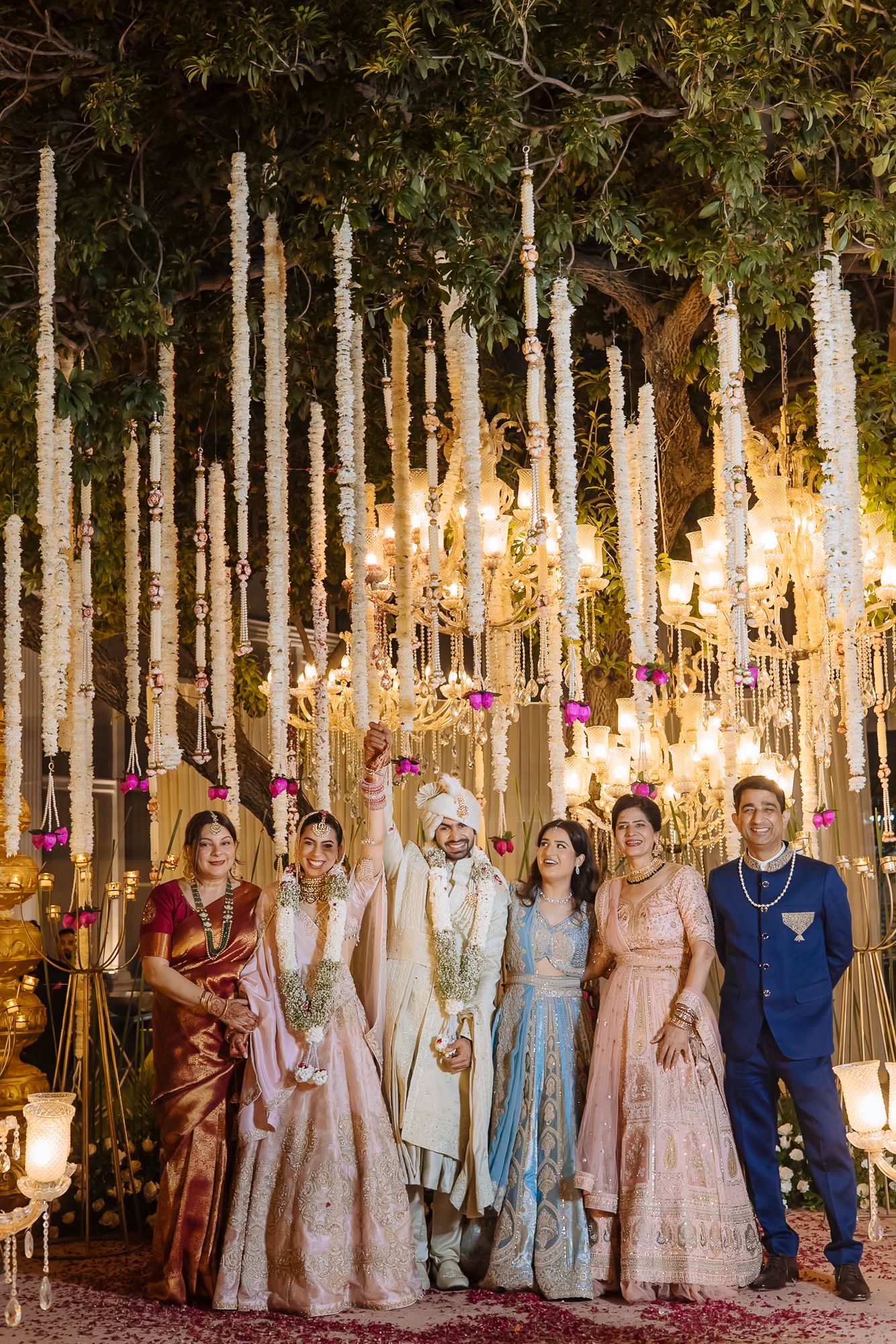 Family reacting joyfully to Shorye and Leah’s varmala ceremony at Tivoli Chattarpur