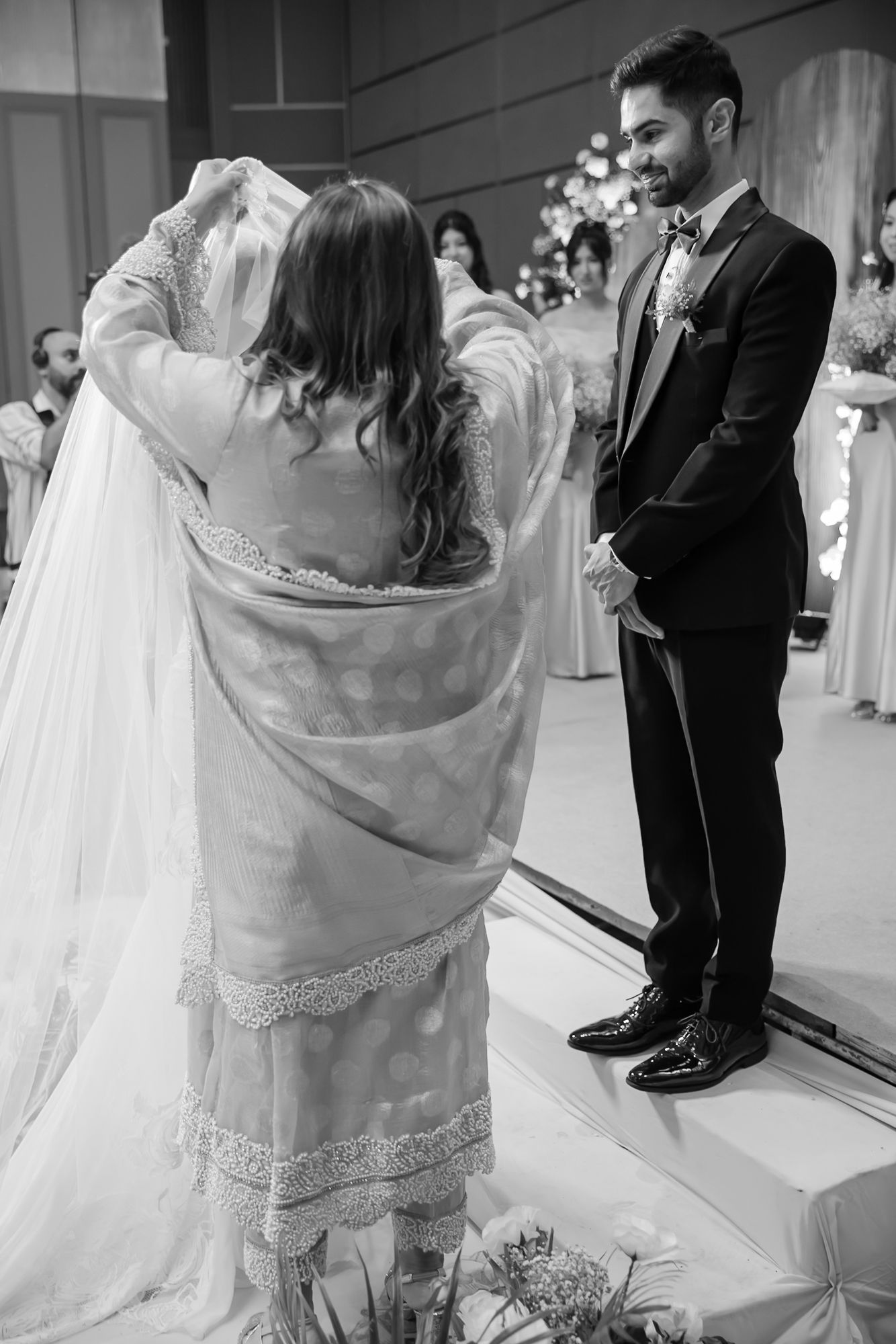 Leah walking down the aisle with her mother during her Christian wedding ceremony at Tivoli Chattarpur
